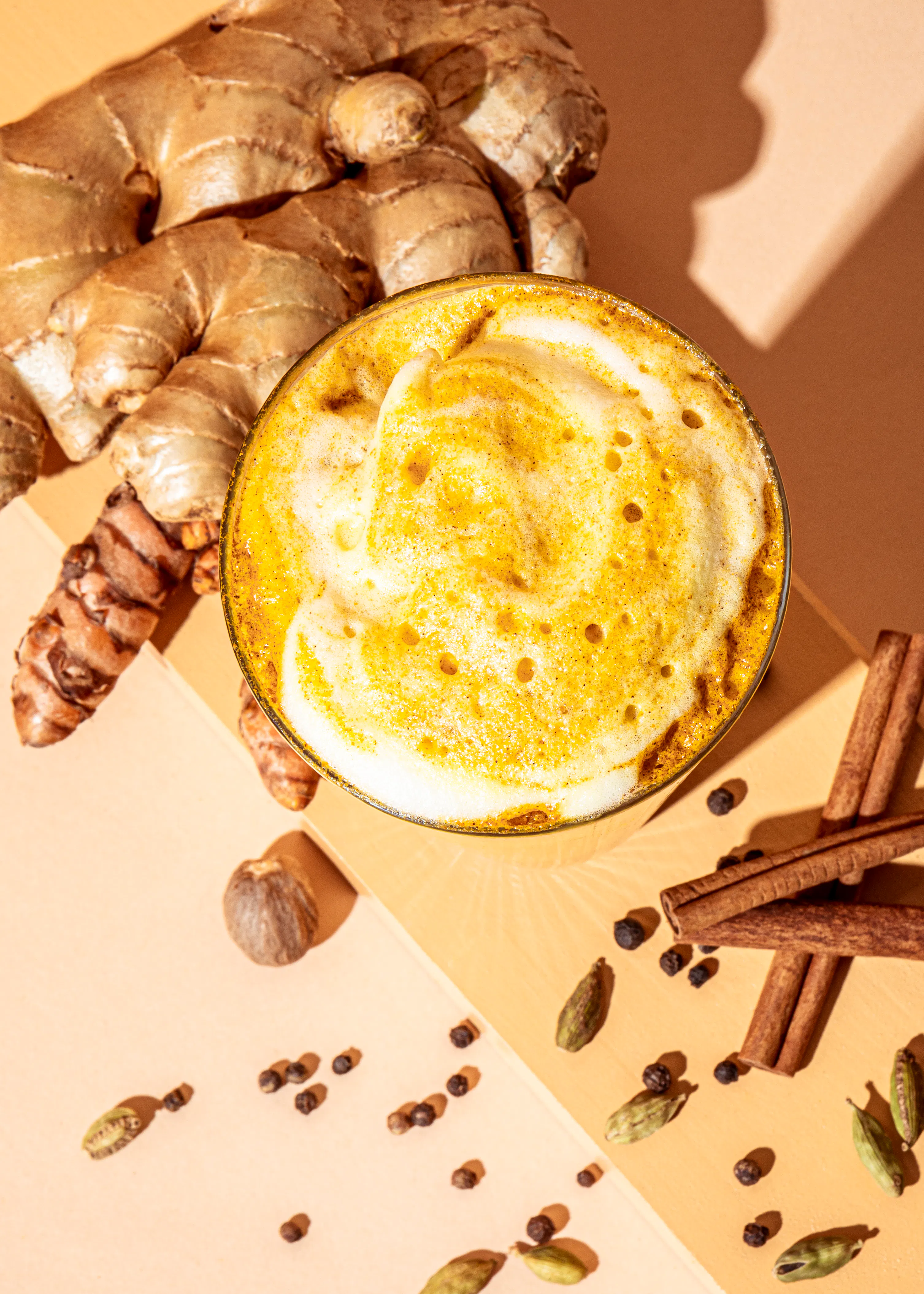 une tasse de boisson entourée de gingembre et de cannelle