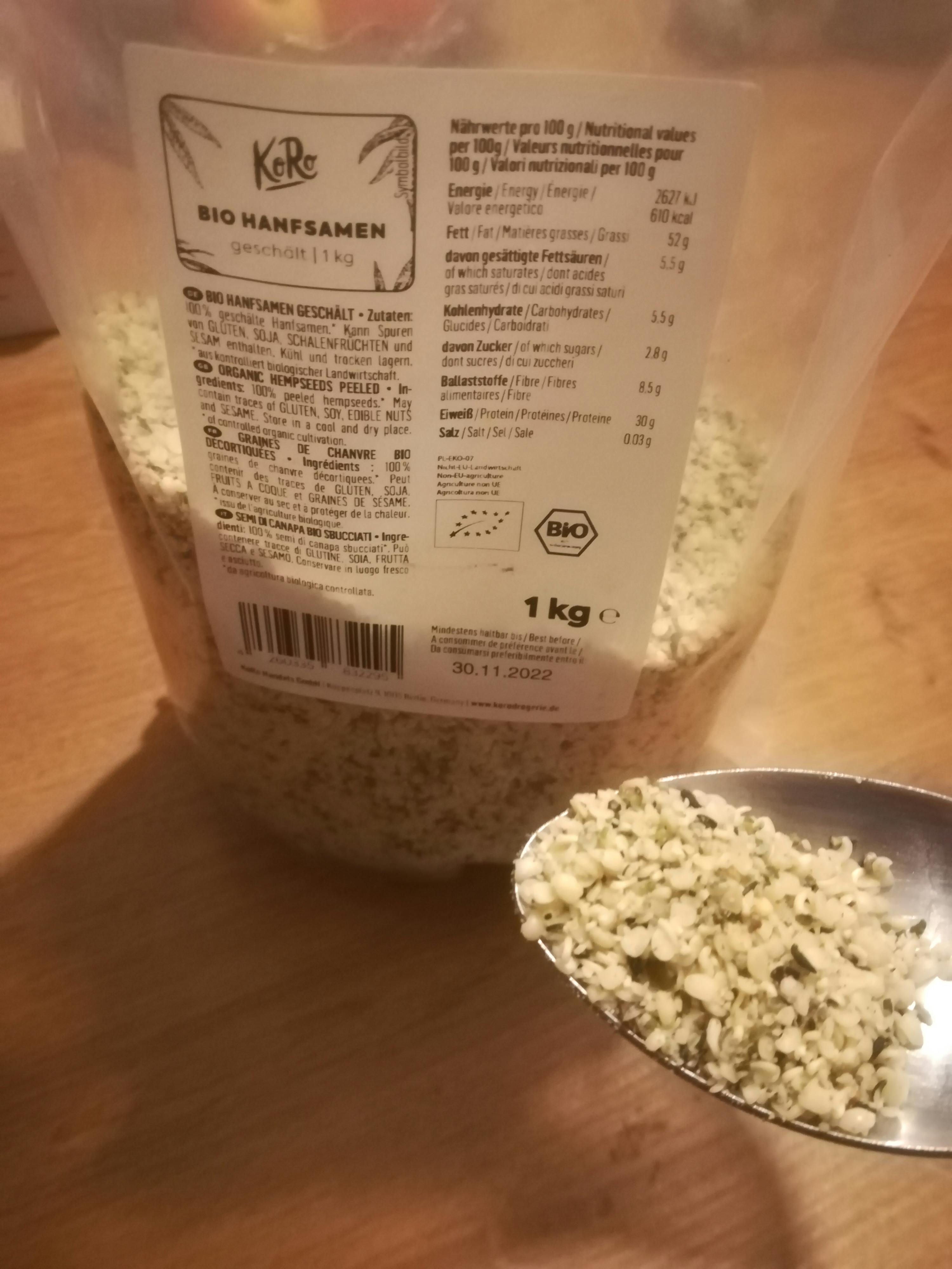 a spoon full of hemp seeds next to a bag of hemp seeds