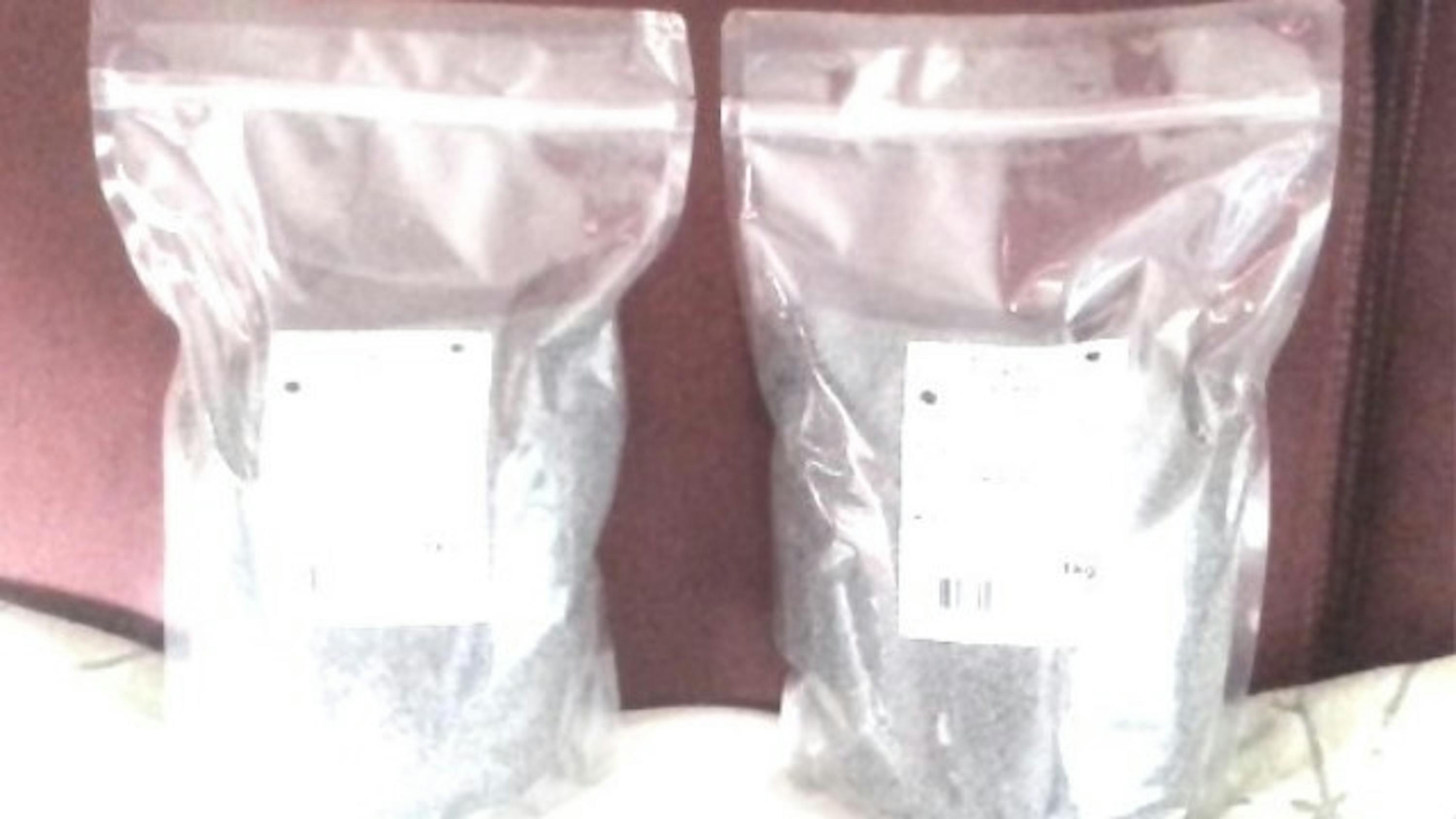 two clear plastic bags are sitting next to each other