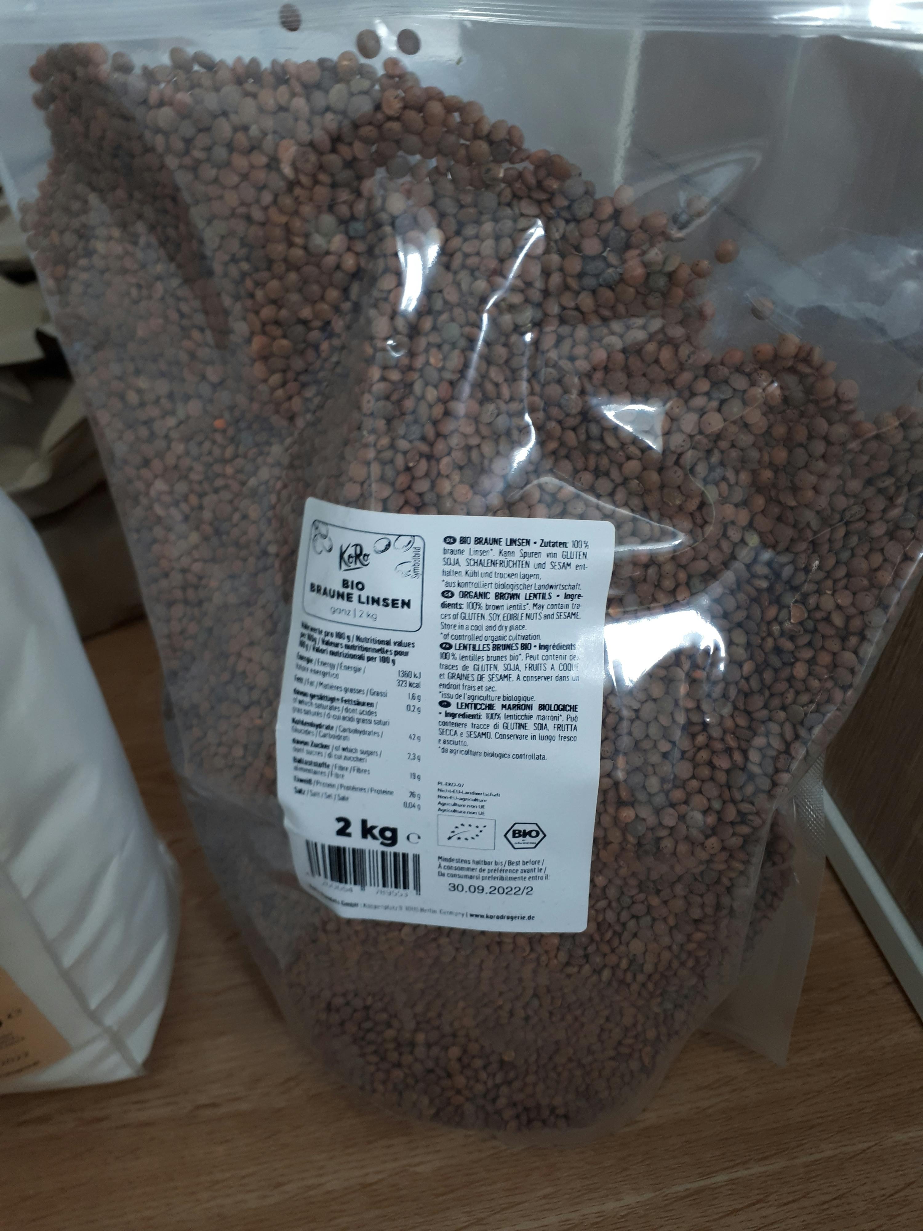 un sacchetto di lenticchie marroni è su un tavolo di legno
