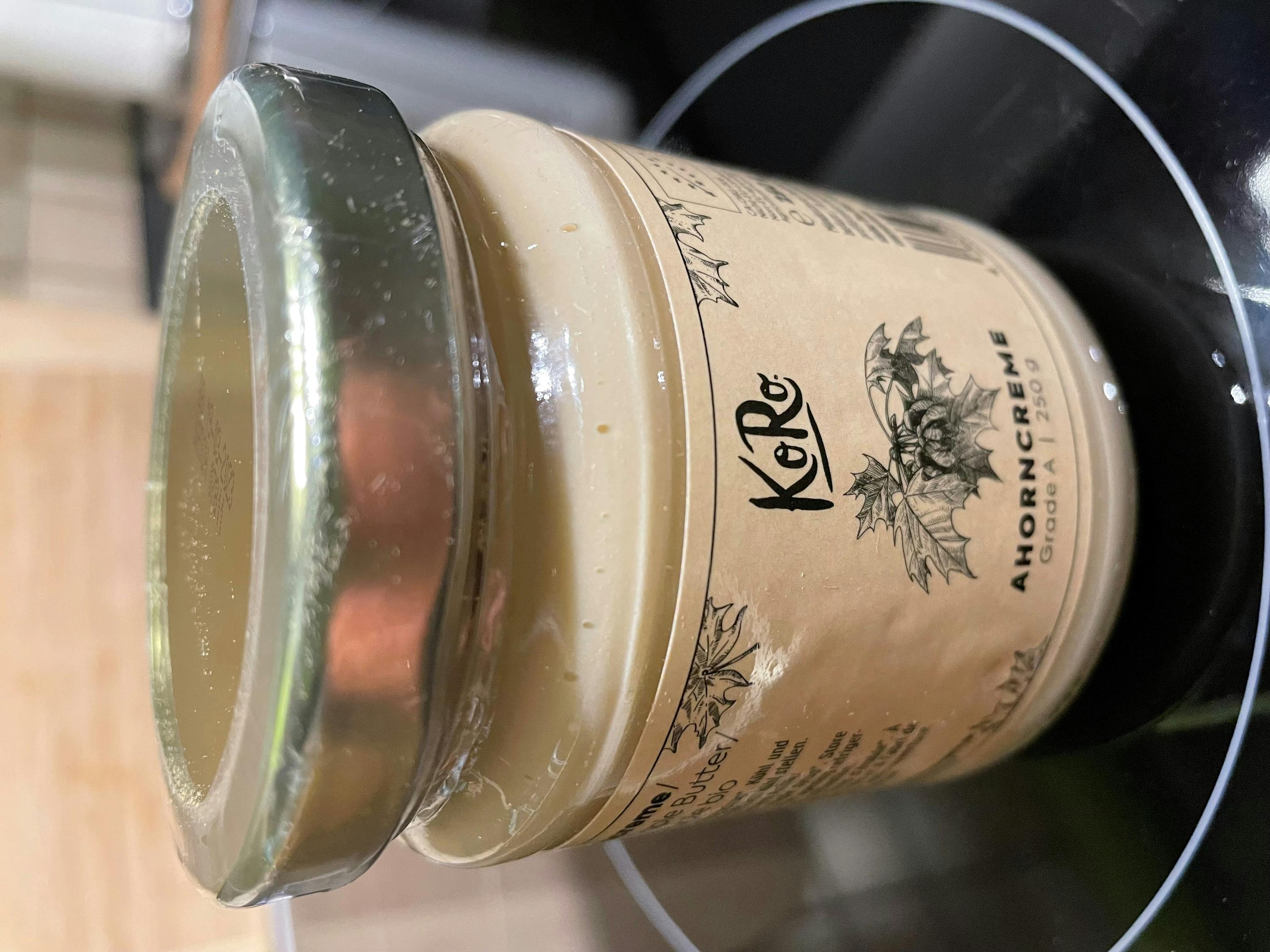 a jar of kore ahorncreme sits on a stove