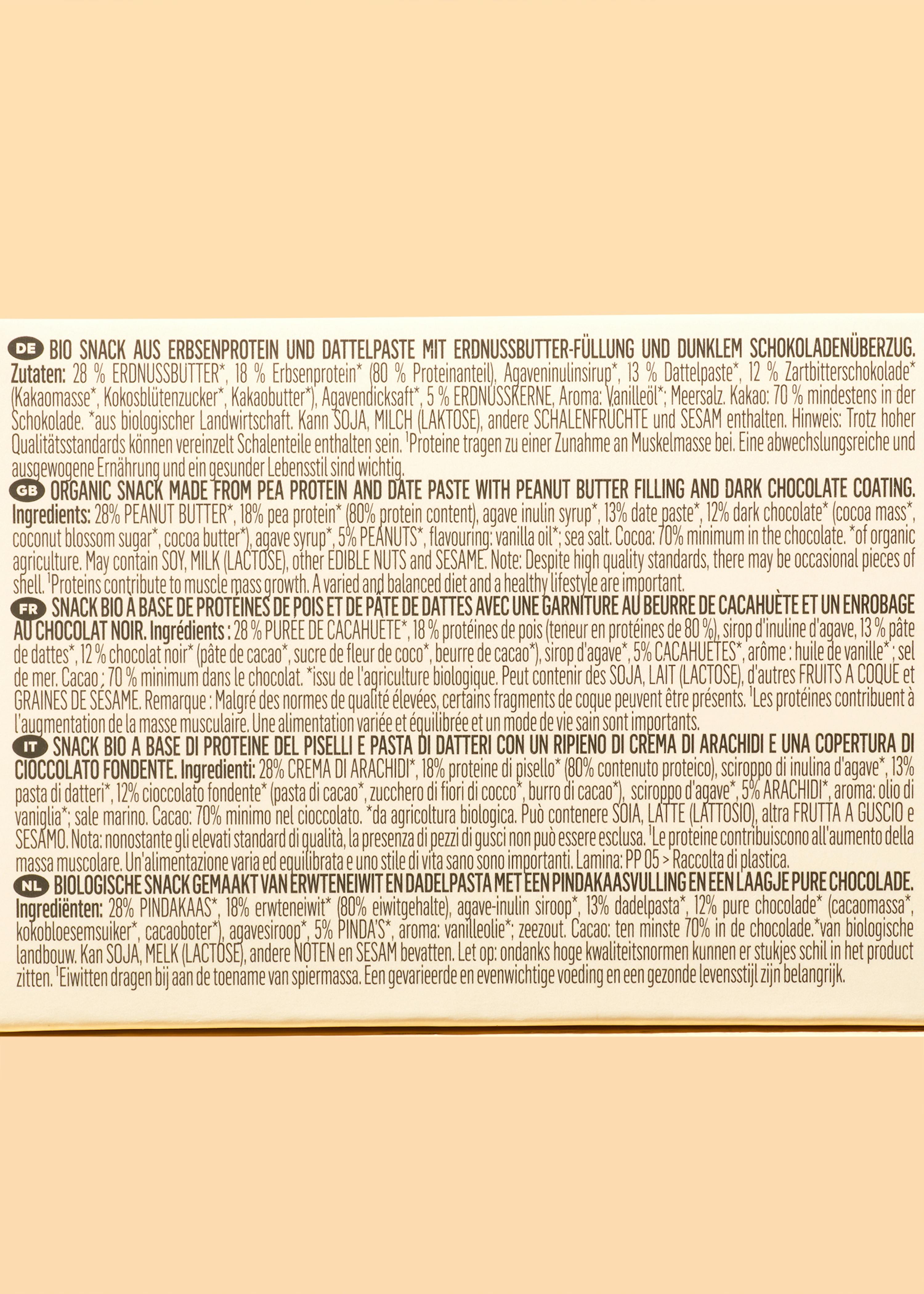 the back of a box of peanut butter and date paste with dark chocolate coating .