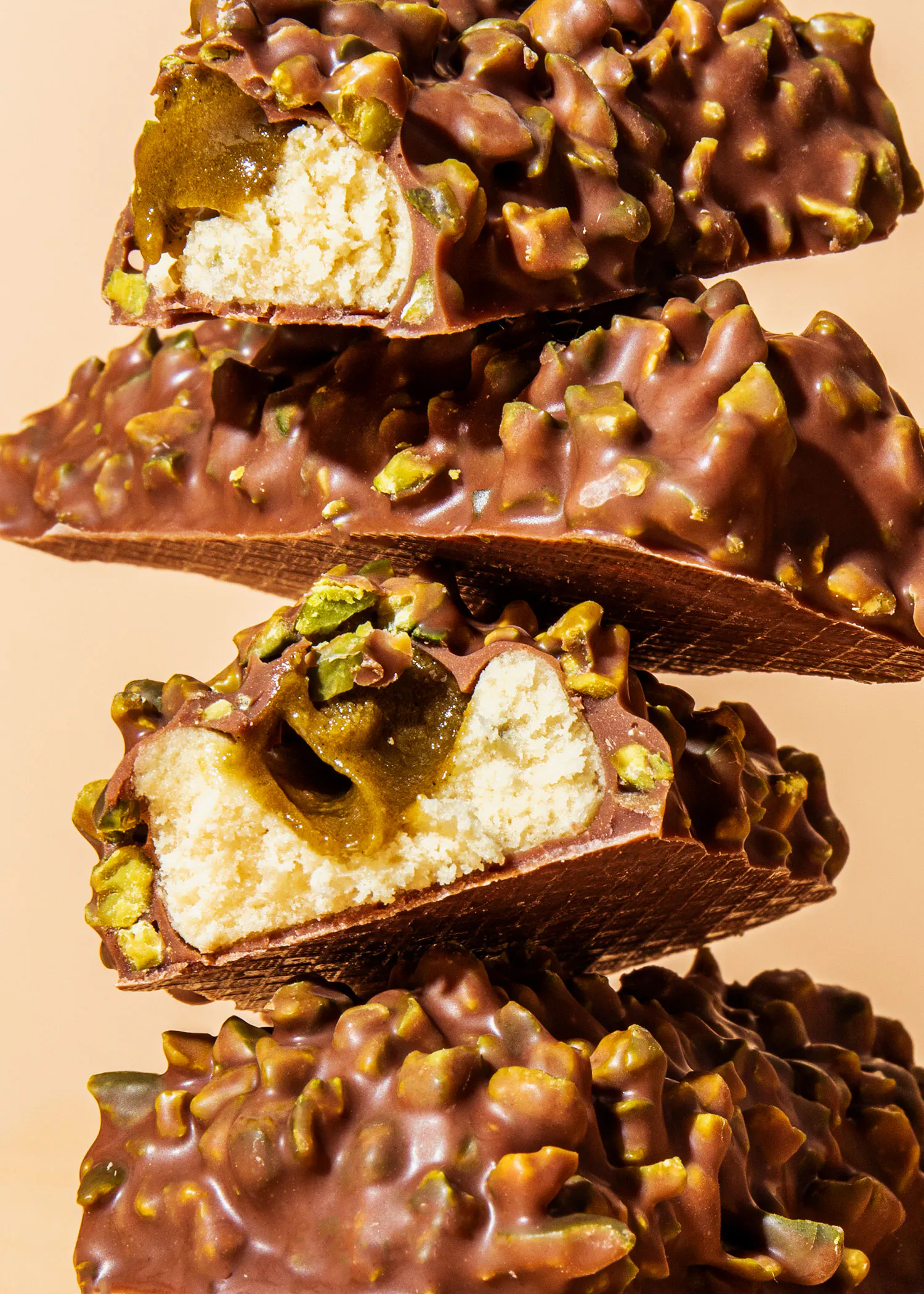 a stack of chocolate bars with pistachios on them