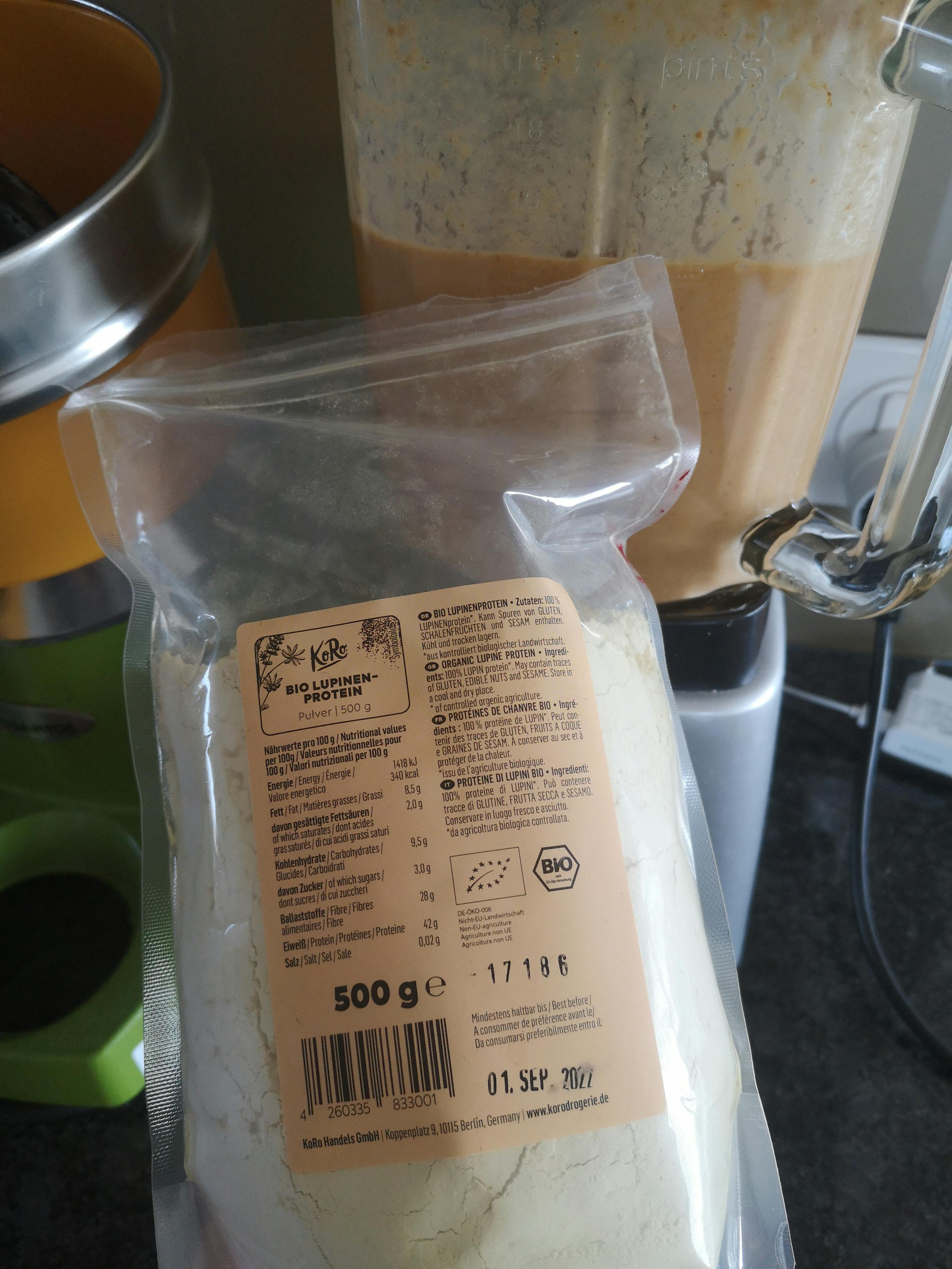 a bag of bio lotus protein sits next to a blender
