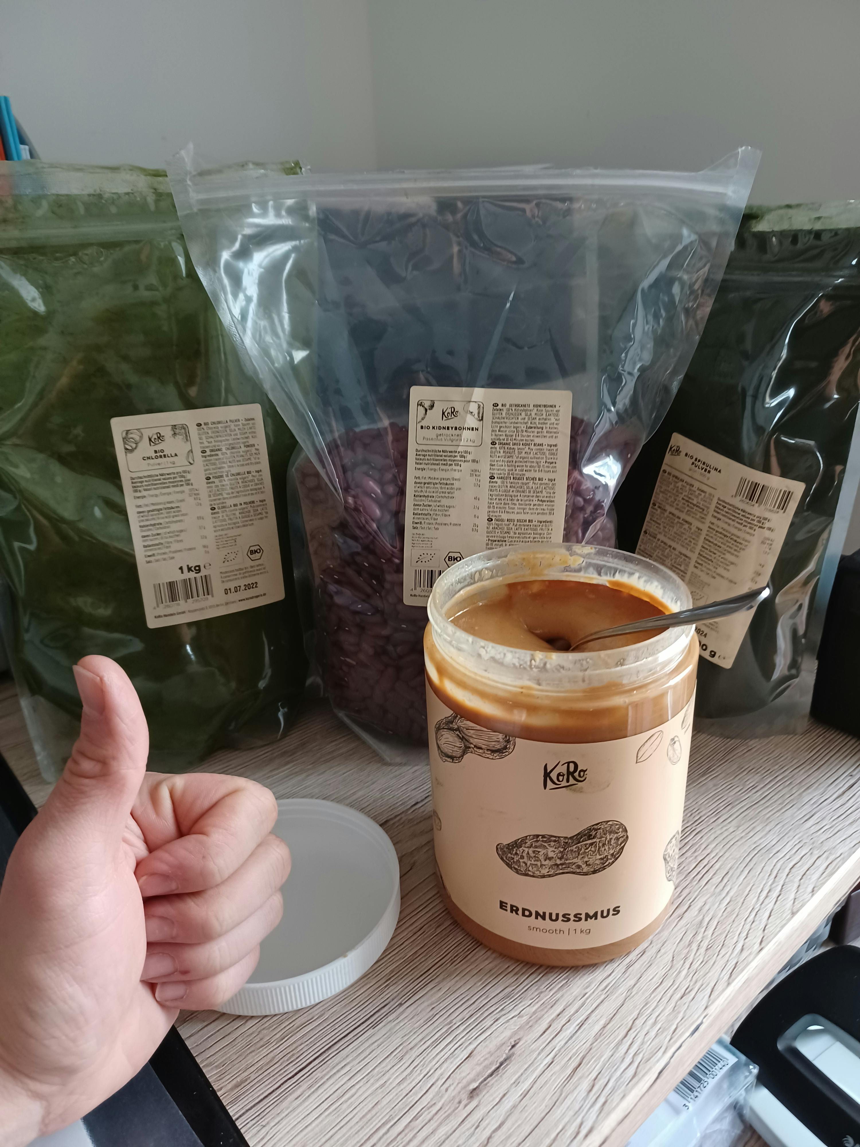 a jar of kr peanut butter sits on a table