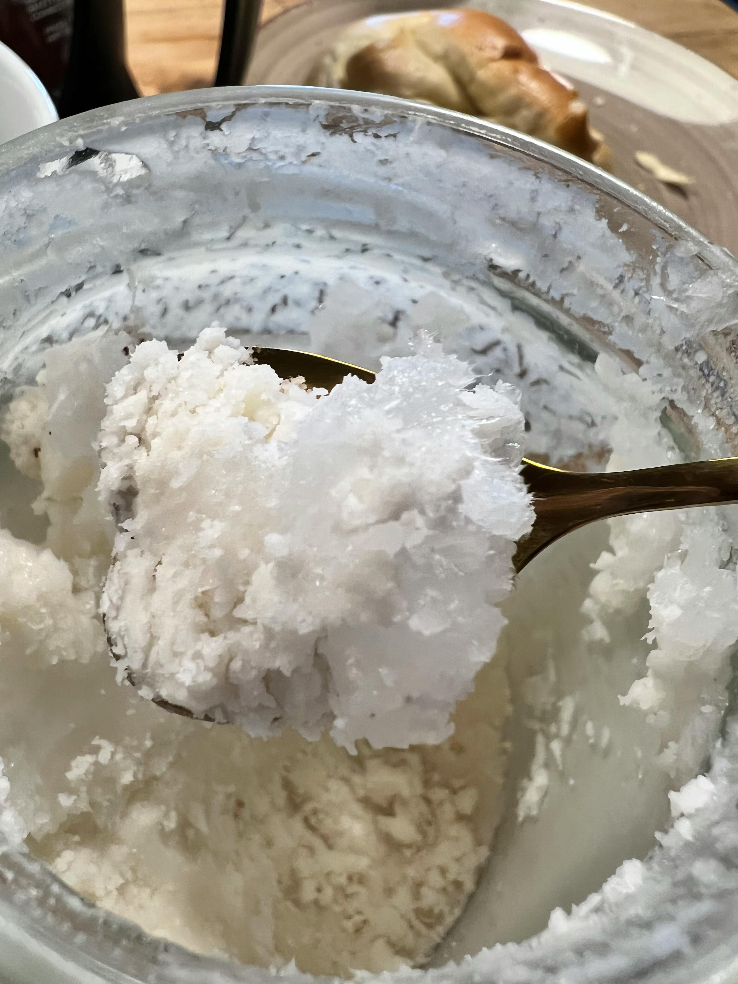 a close up of a spoon in a bowl of white powder