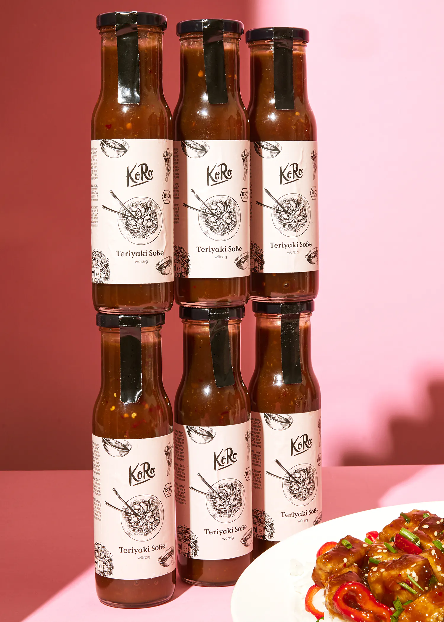 six bottles of teriyaki sauce stacked on top of each other