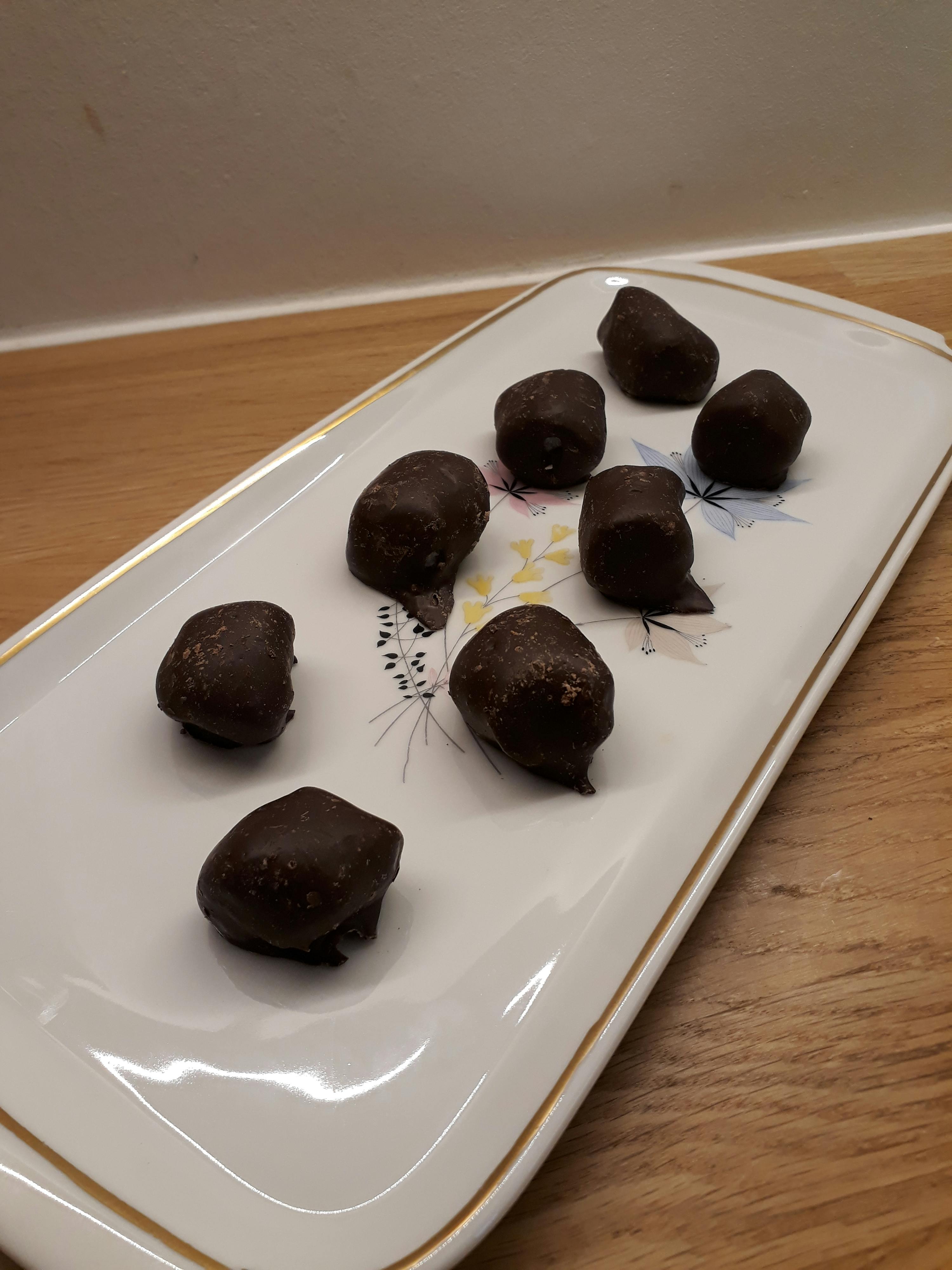 a white plate with chocolate balls on it