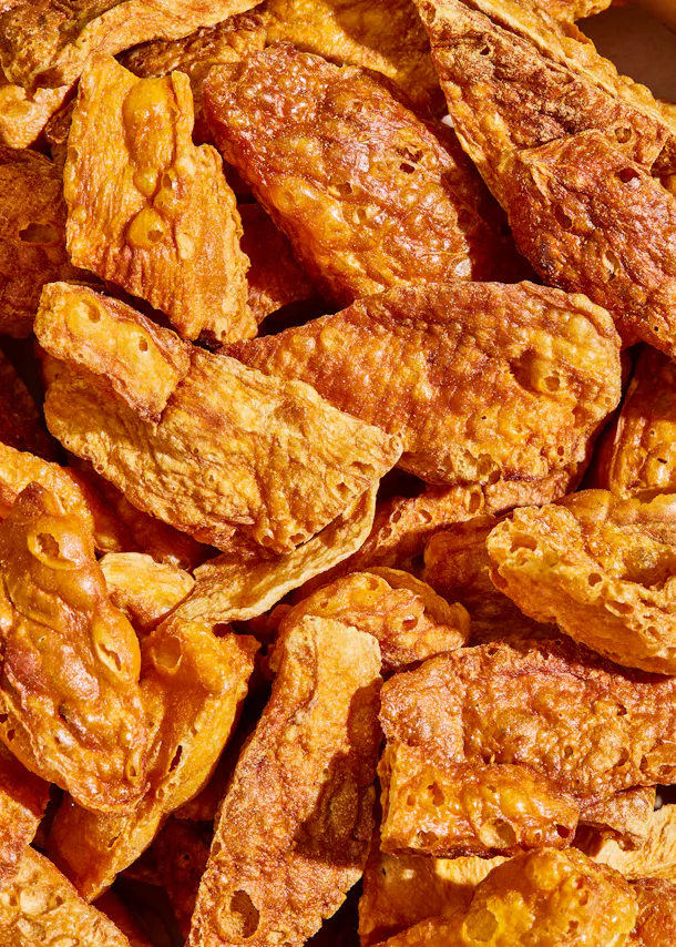 a close up of a pile of crackers with holes in them