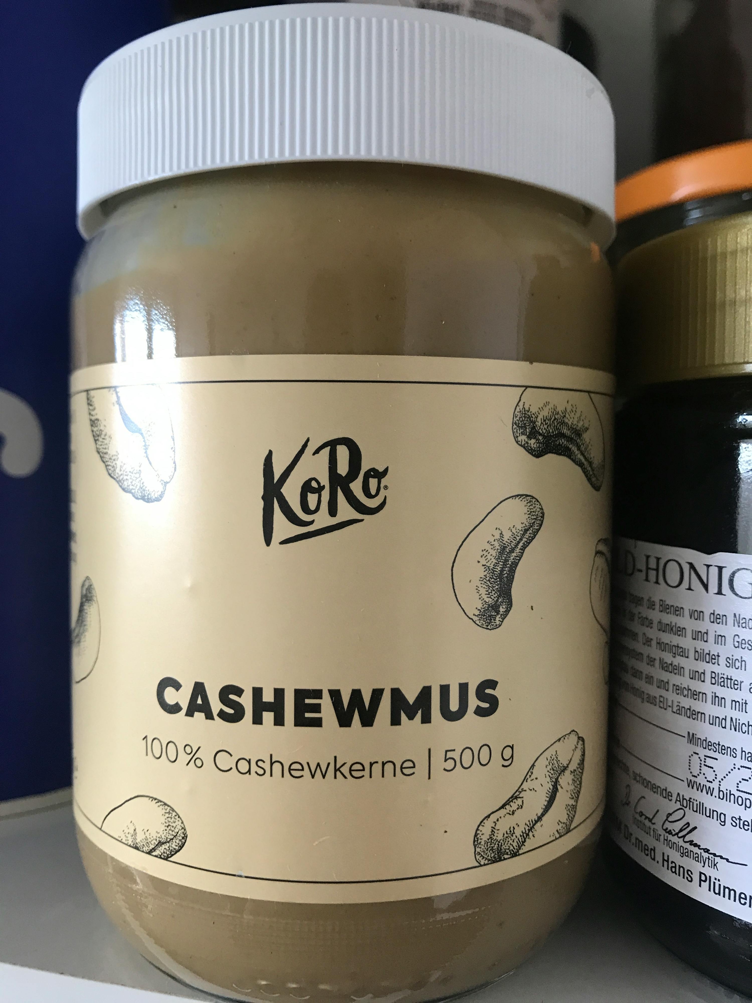 a jar of cashewmus sits next to a jar of honey
