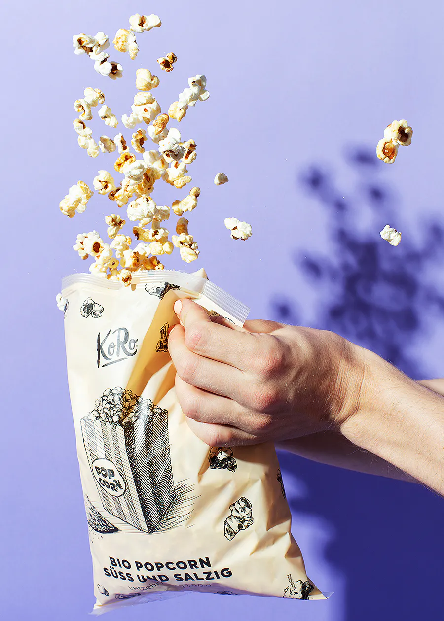 une personne tient un sac de pop-corn bio