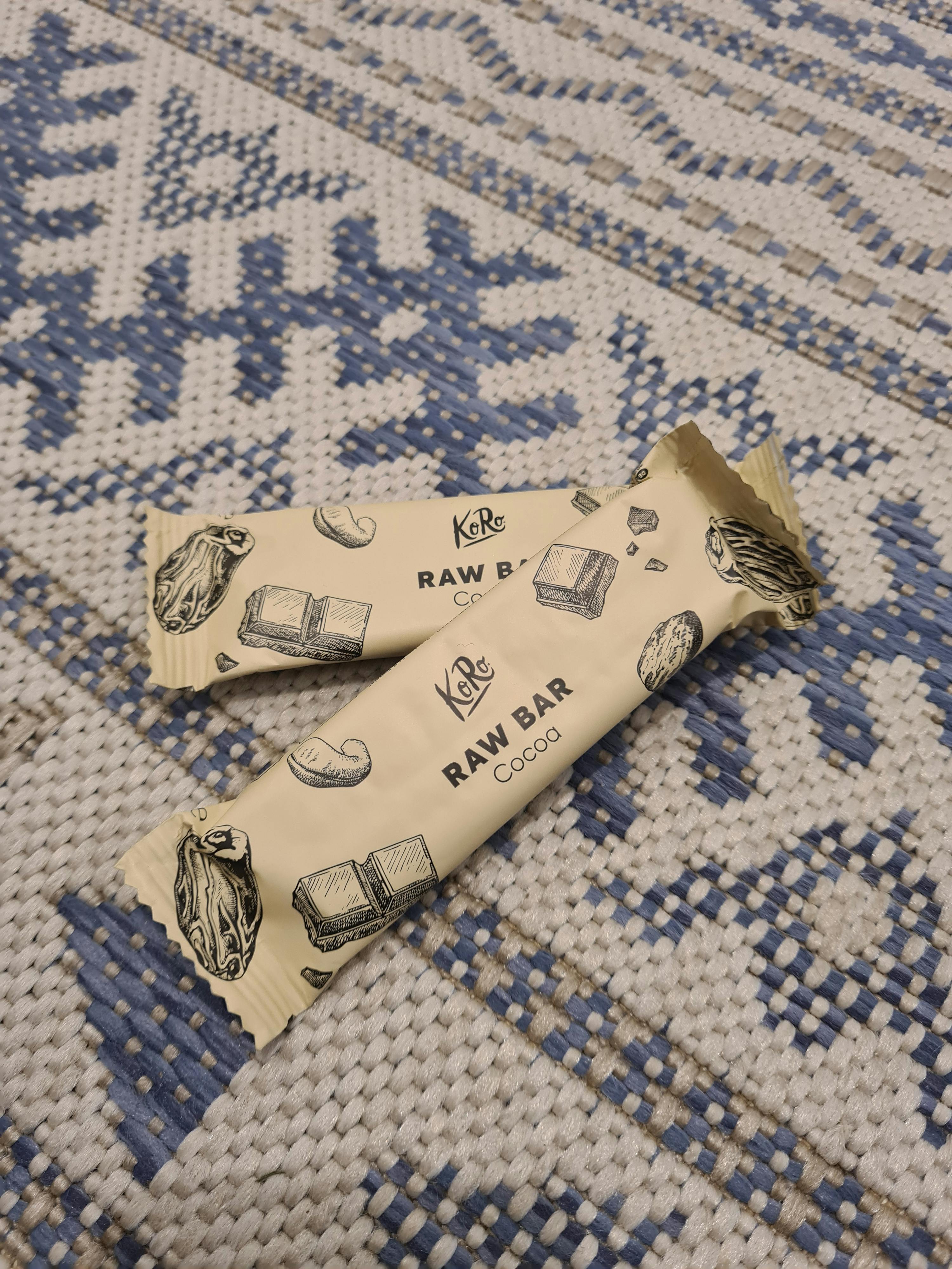 two bars of raw bar cocoa are on a blue and white rug