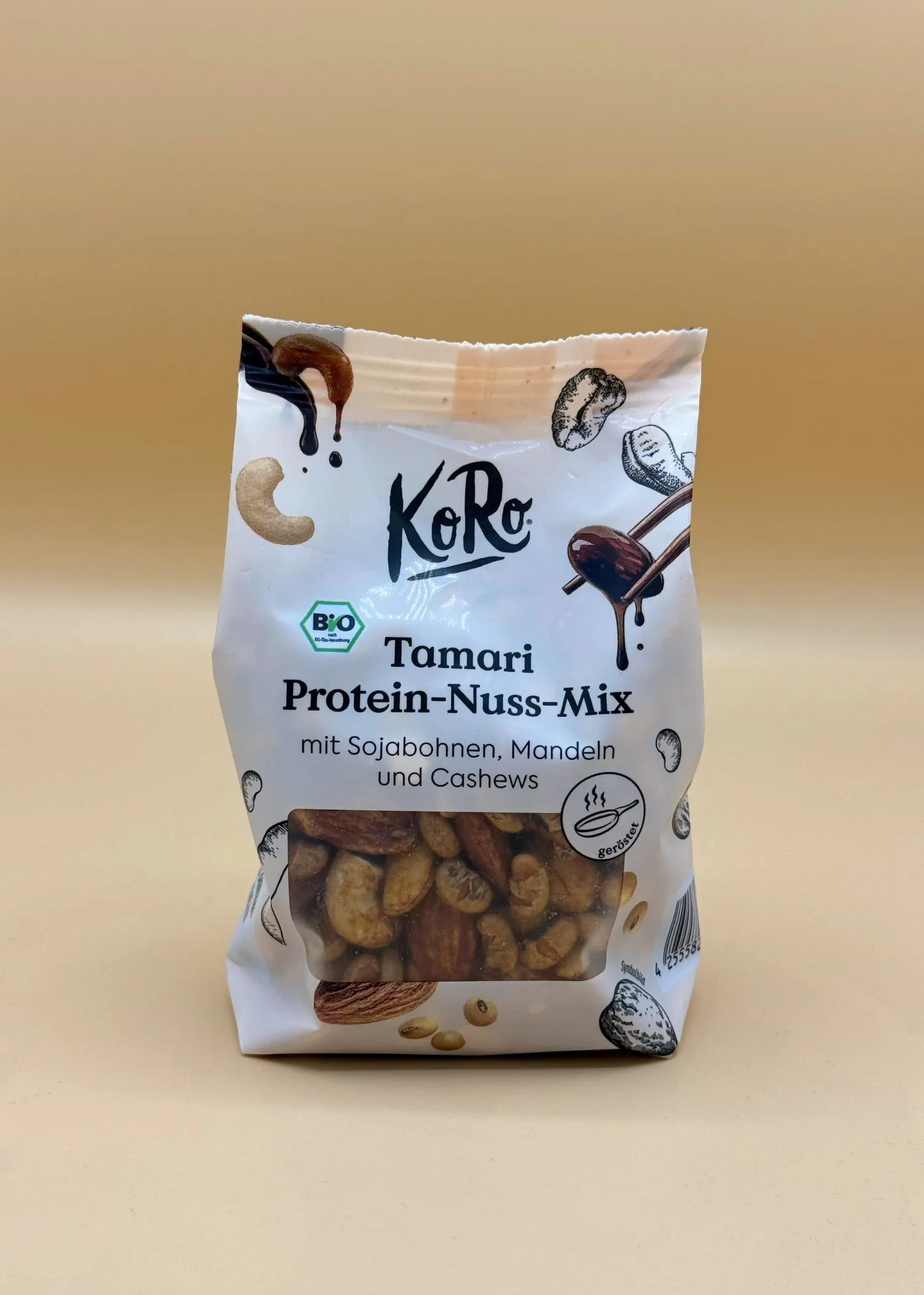 a koro tamari protein-nuss-mix bag, showing organic roasted soybeans, almonds, and cashews through a clear window.