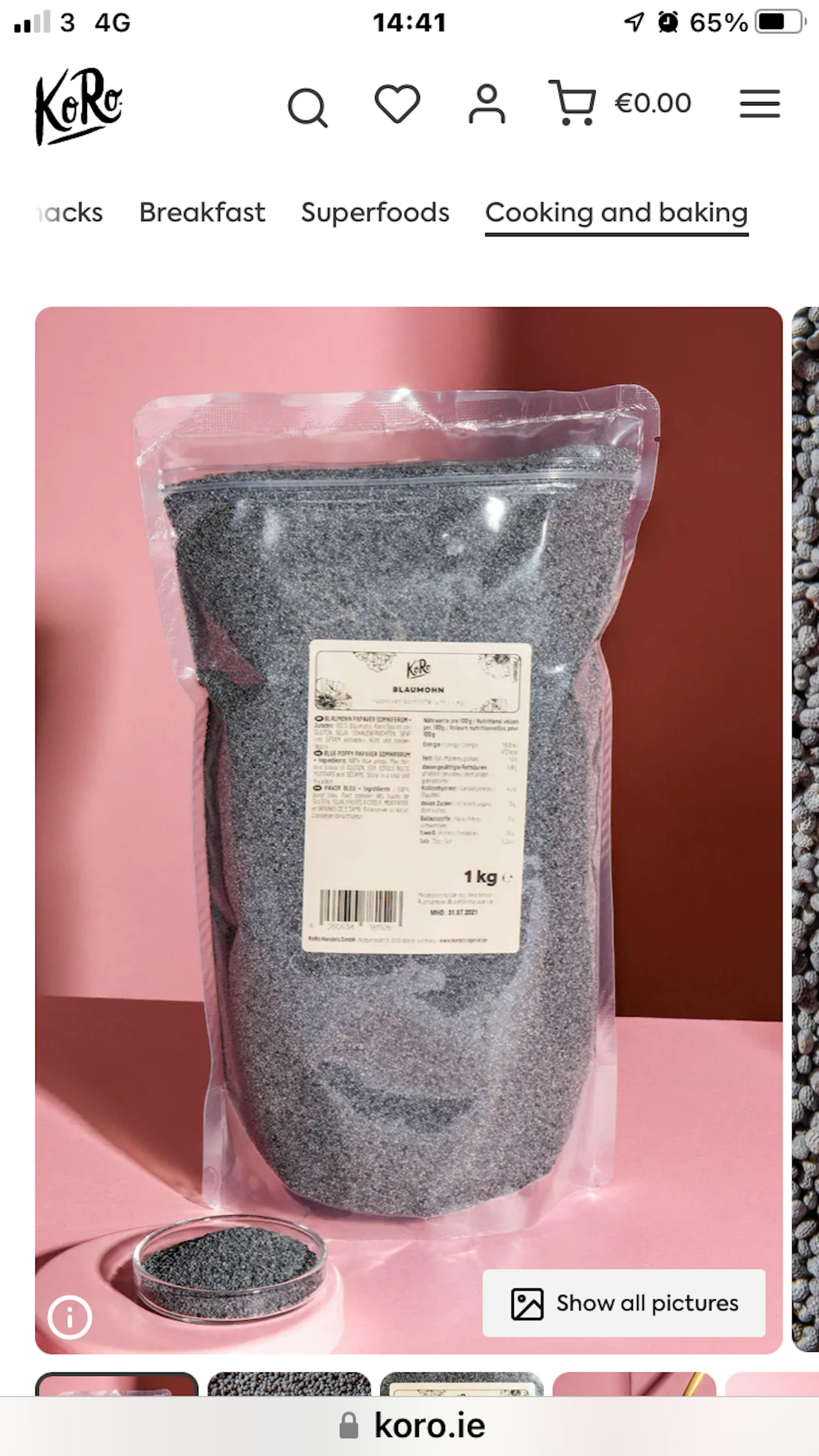 a bag of black seeds sits on a pink surface