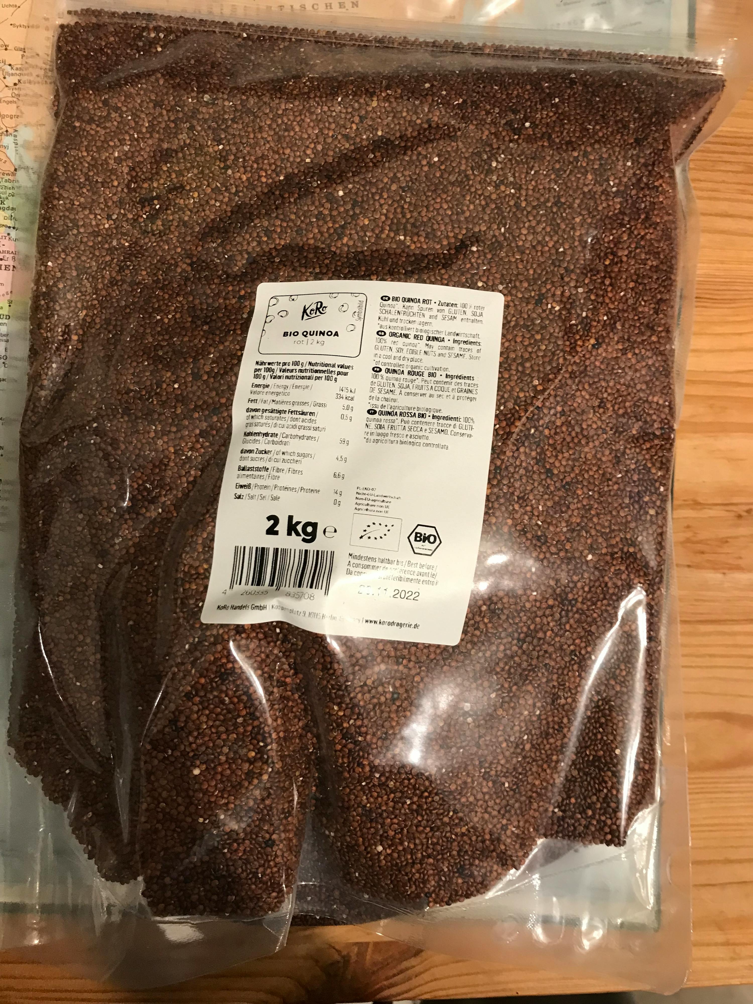 a bag of bio quinoa seeds sitting on a wooden table