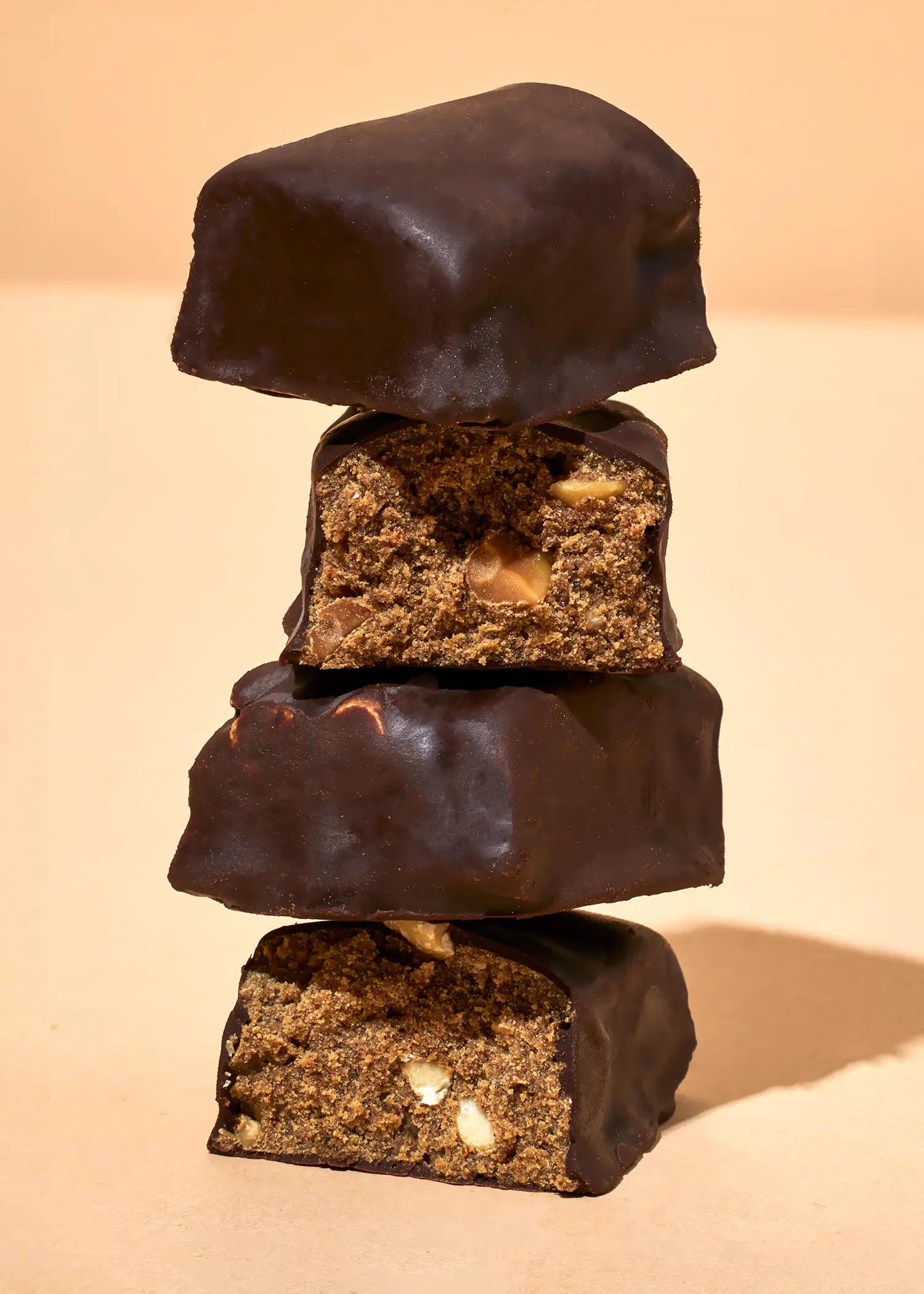 three chocolate covered brownies are stacked on top of each other