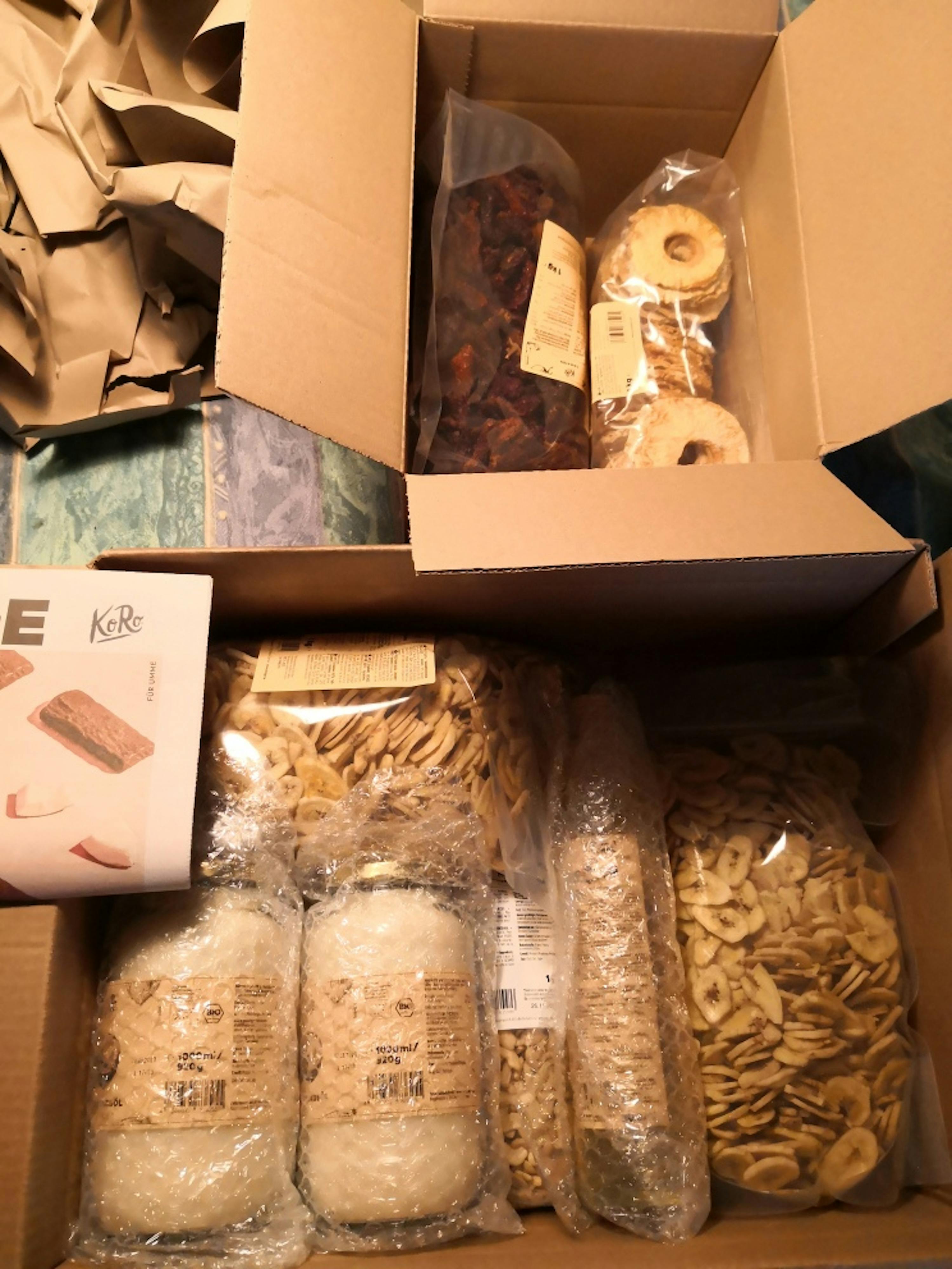 a cardboard box filled with a variety of food items including a box that says e kore