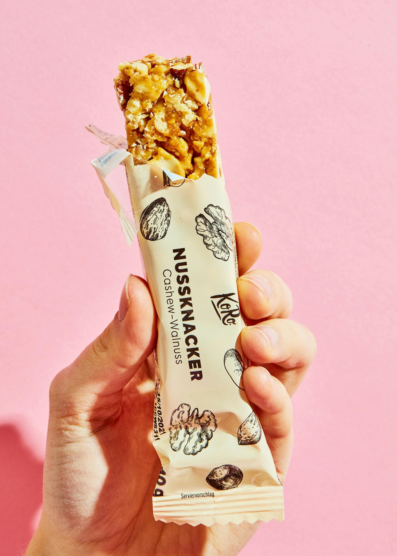 a person is holding a nutcracker bar in their hand