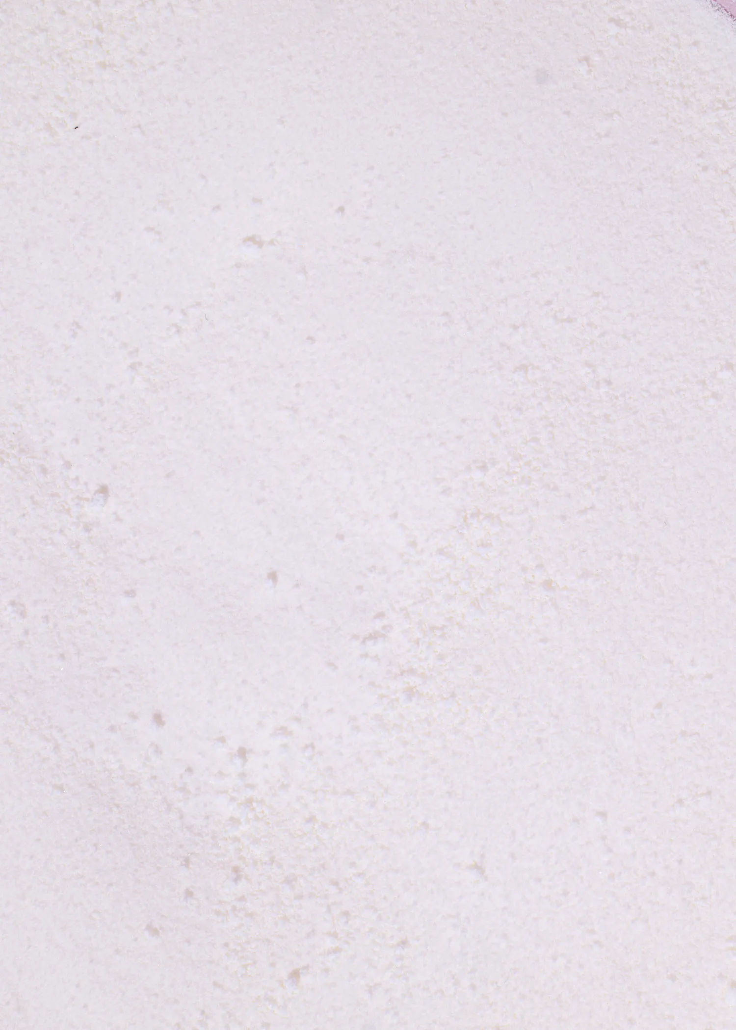 a close-up of a light, textured, off-white surface with subtle pink undertones.