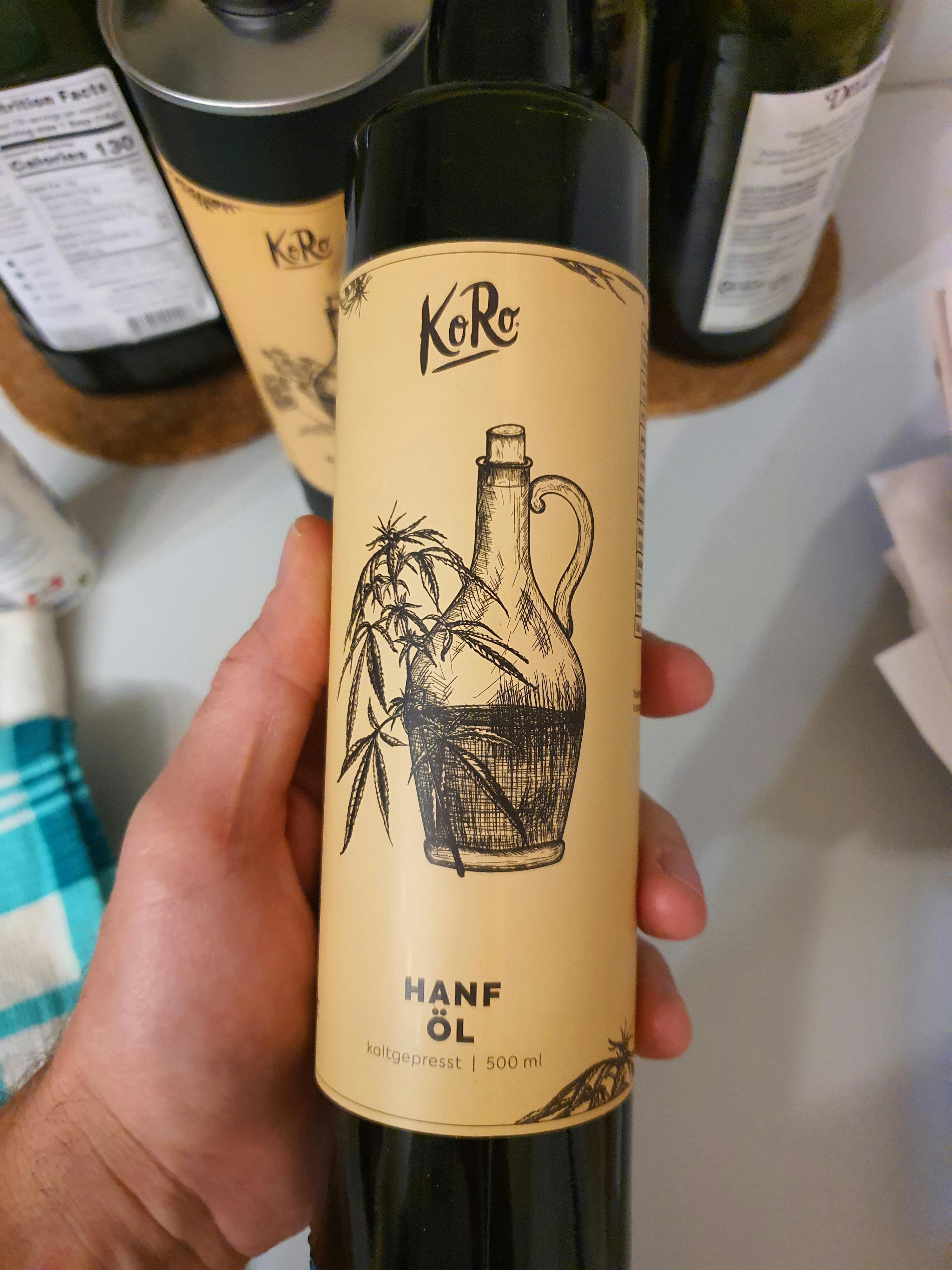 a person is holding a bottle of hanf oil in their hand