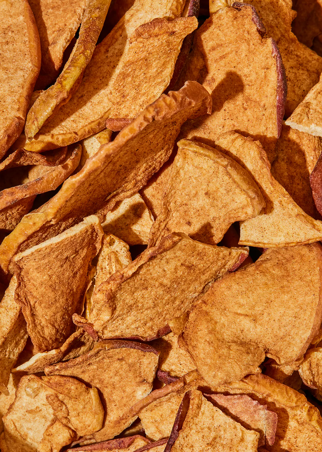 a close up of a pile of dried apple chips