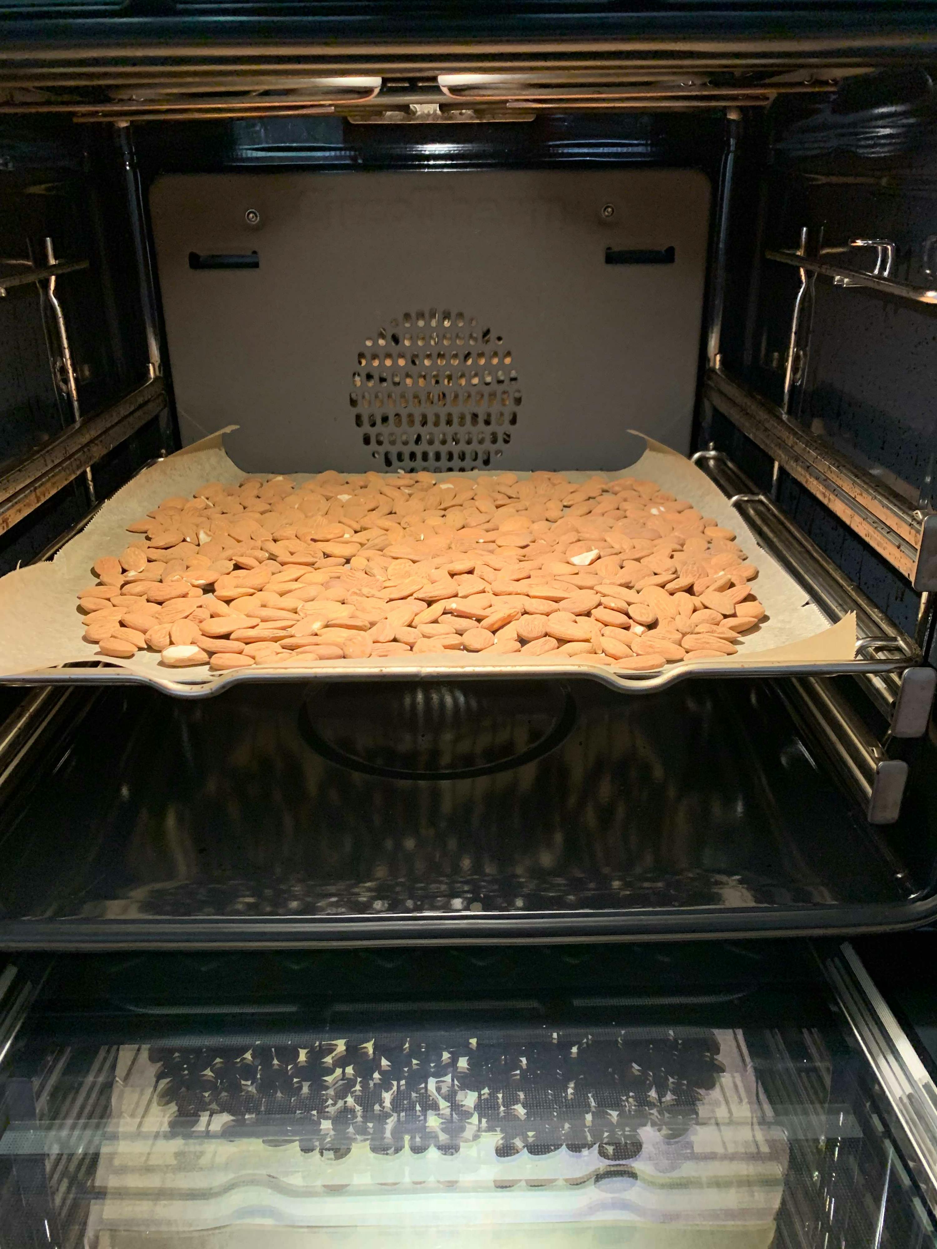 almonds are being baked in an oven on a tray