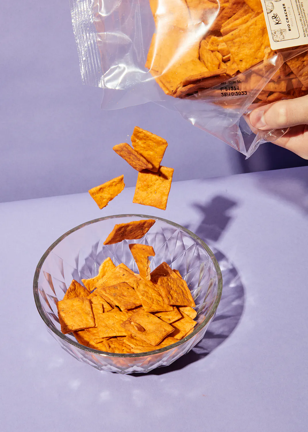 a bag of beef crackers is being poured into a bowl