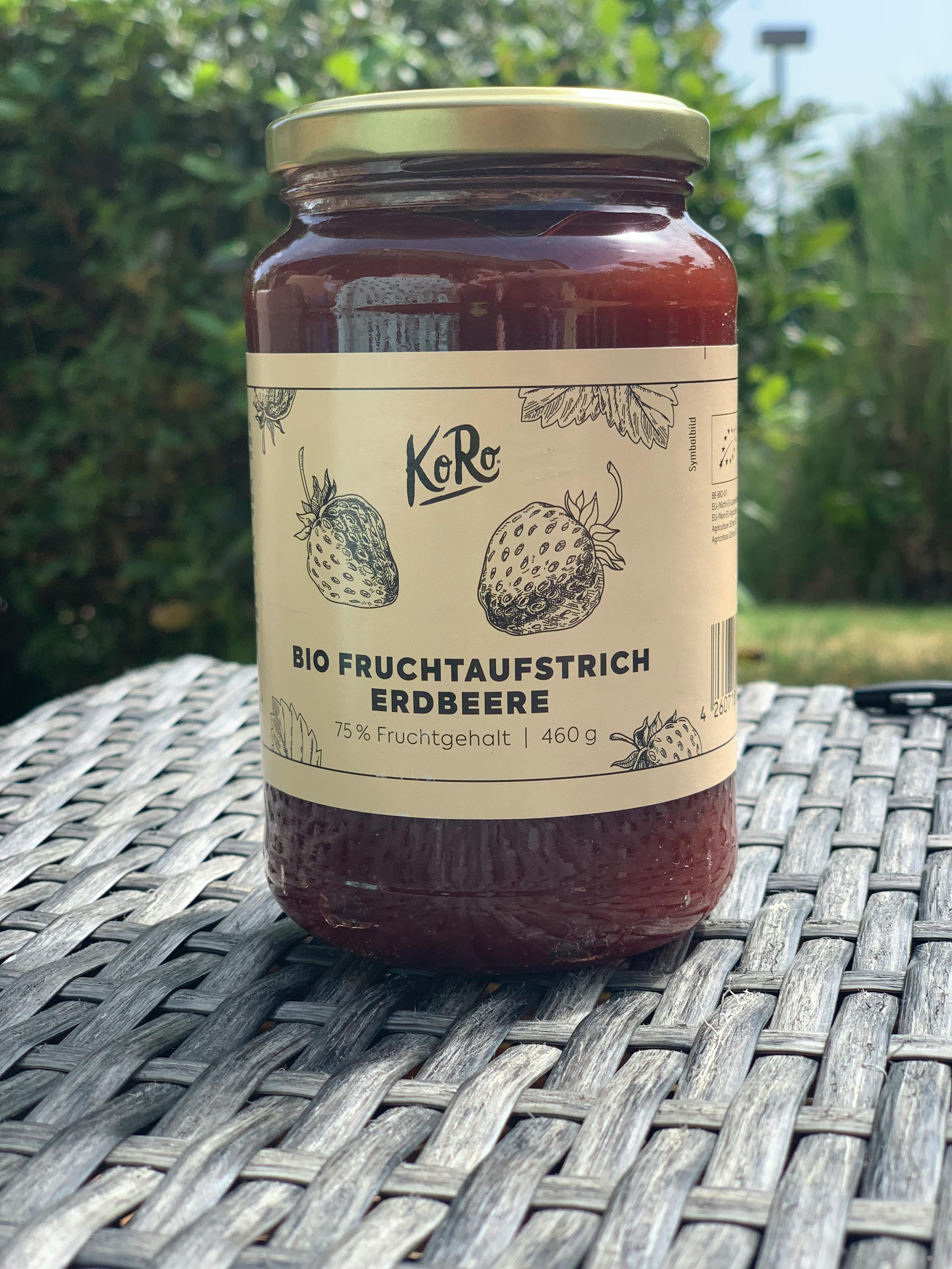 a jar of bio fruchtaufstrich erdbeere is sitting on a wicker table