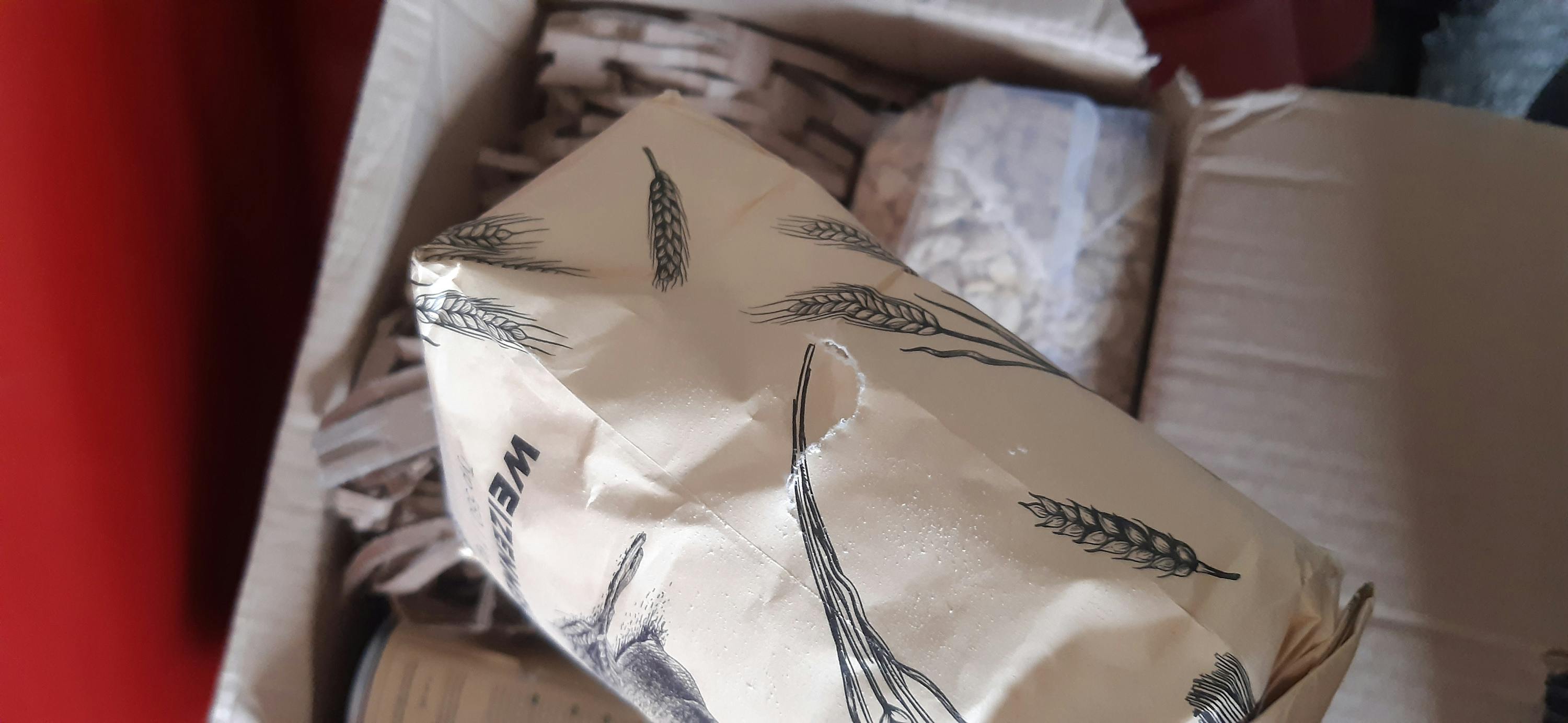 a bag of wheat sits in a box with other items