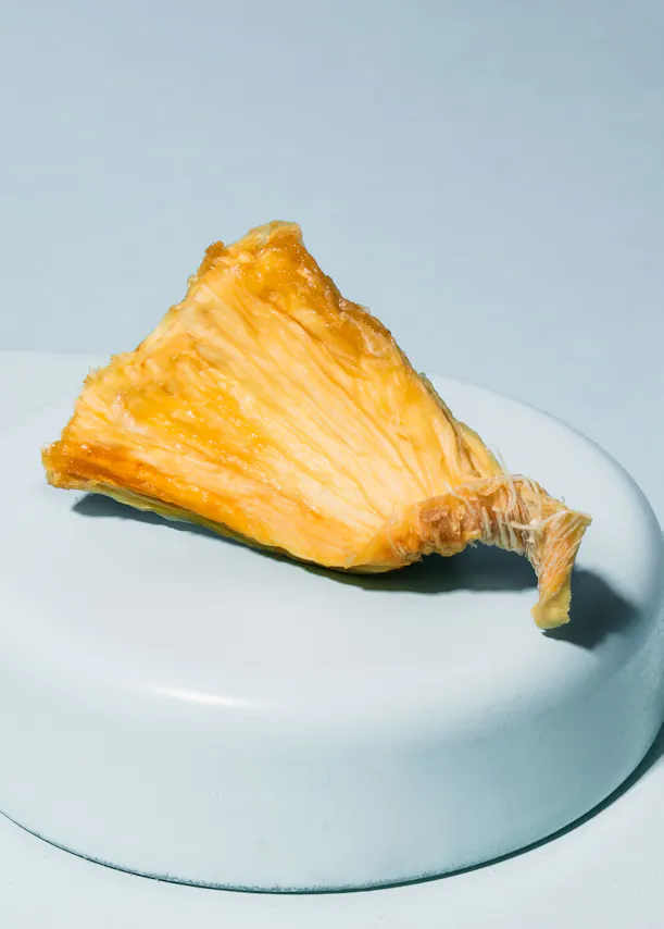 a slice of pineapple on a blue plate