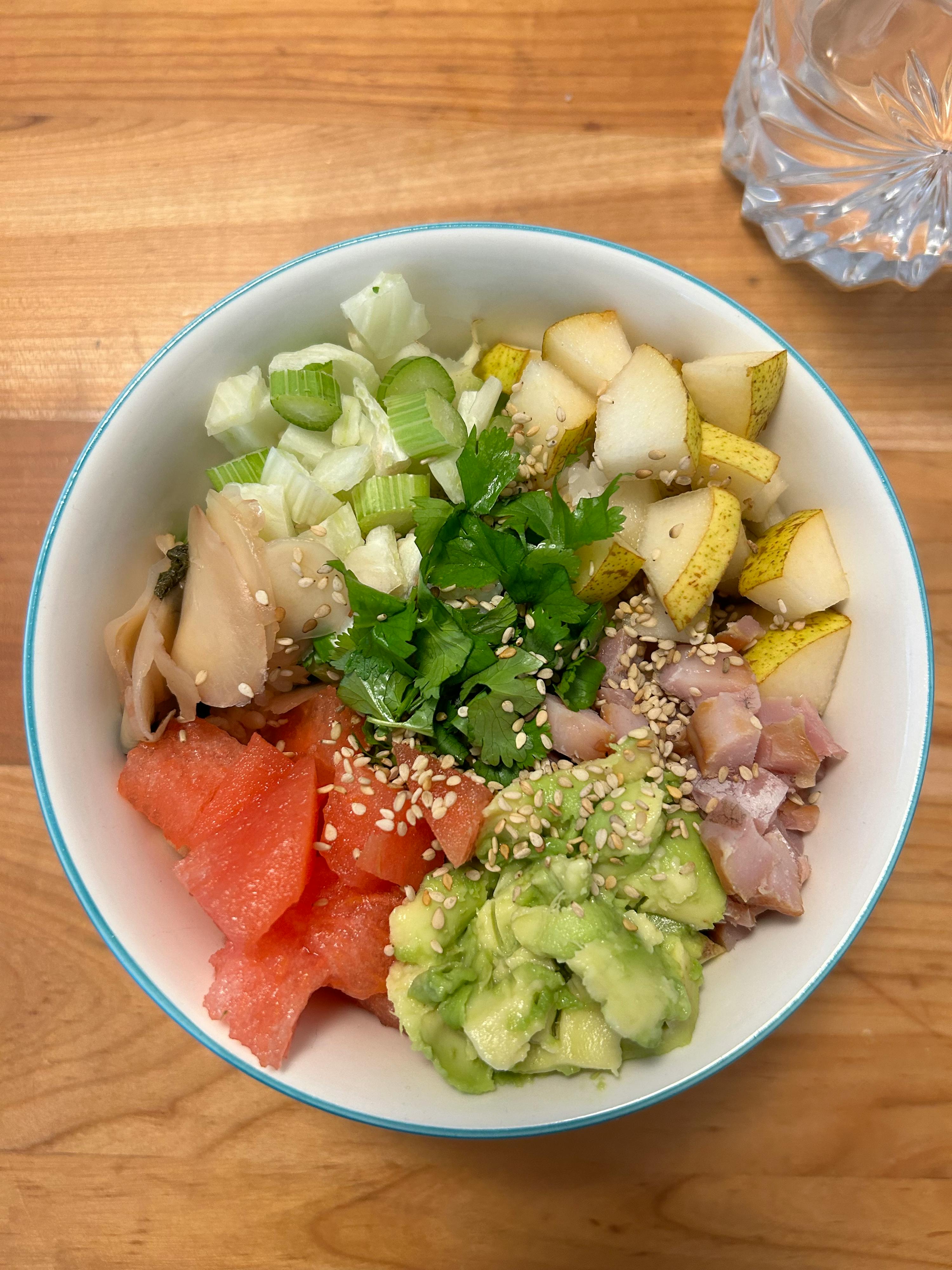 a white bowl filled with a variety of fruits and vegetables
