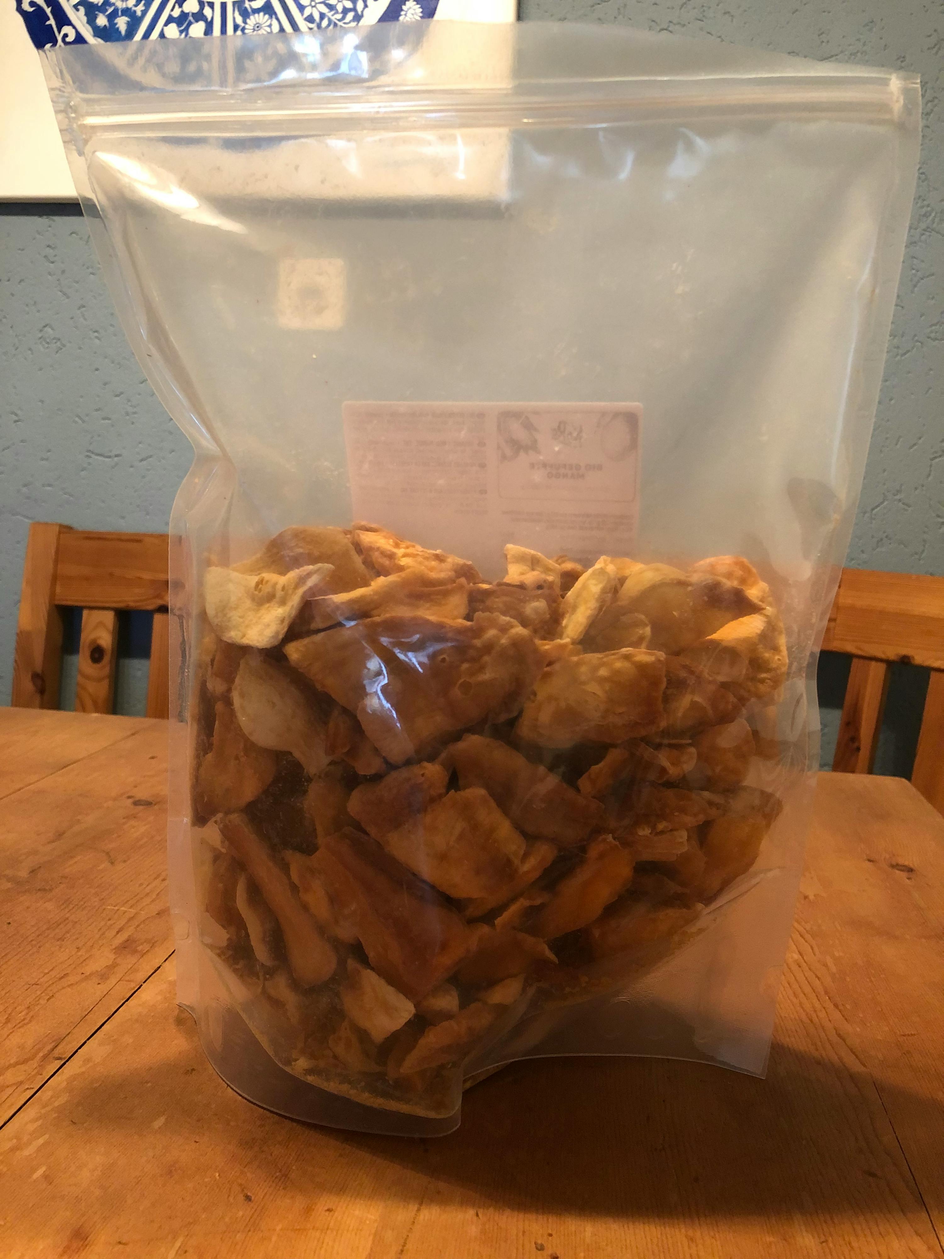 a bag of chips is sitting on a wooden table
