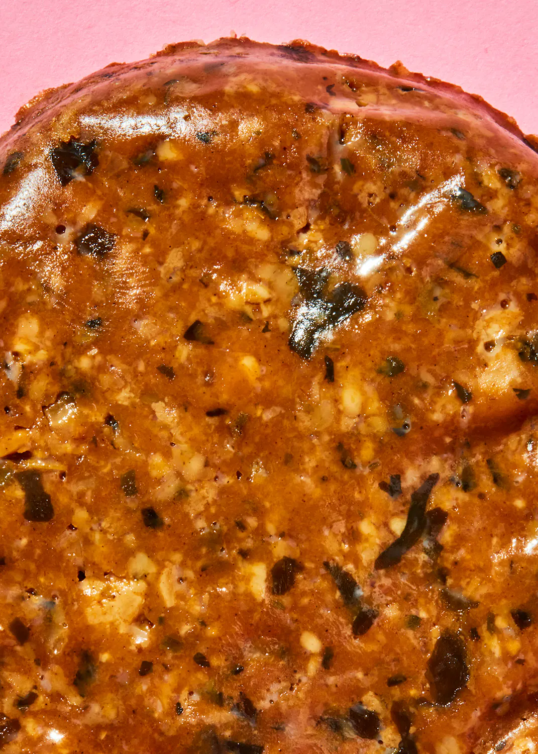 a close up of a piece of food with a pink background