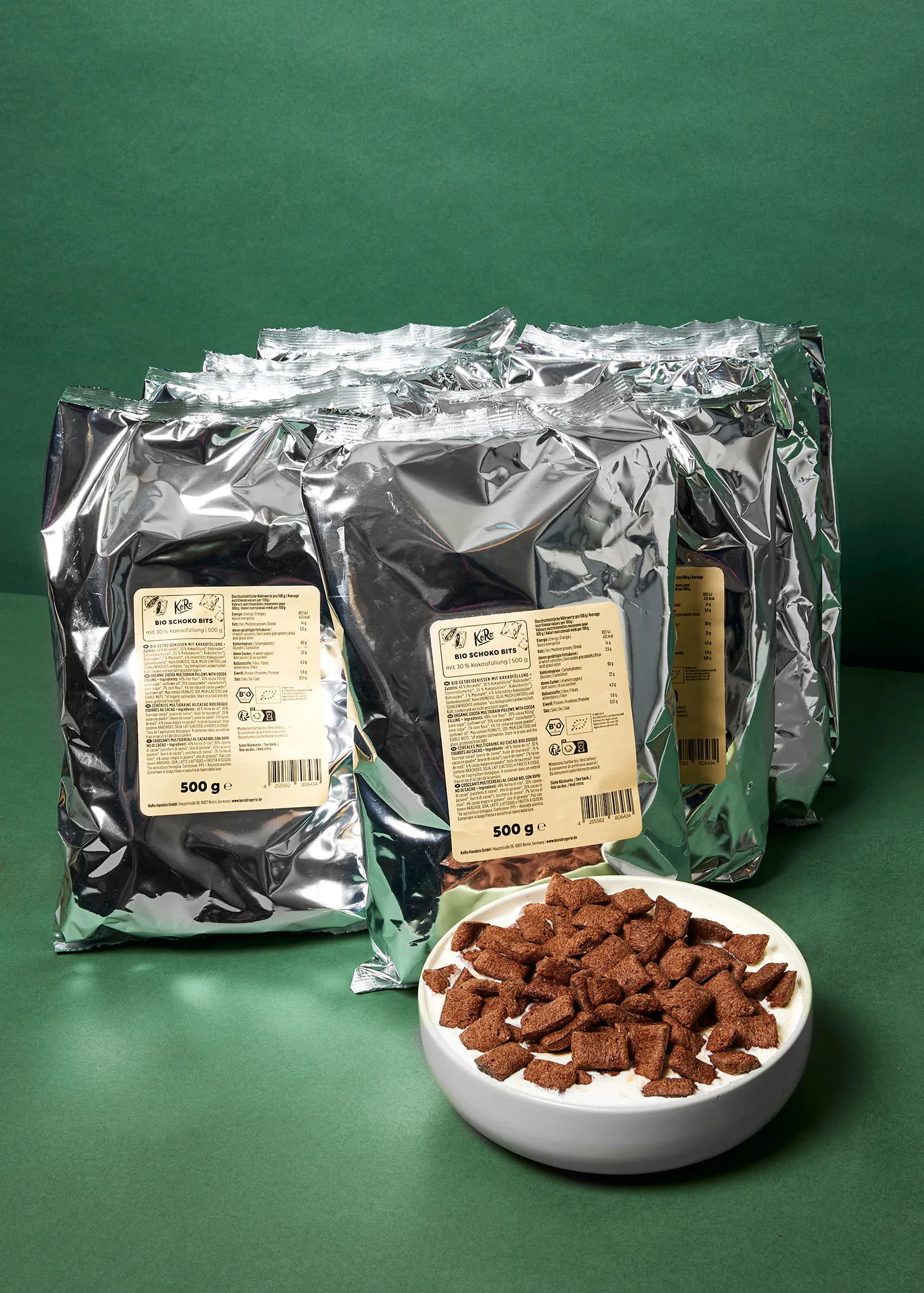 a bowl of cereal sits next to bags of big banana bites