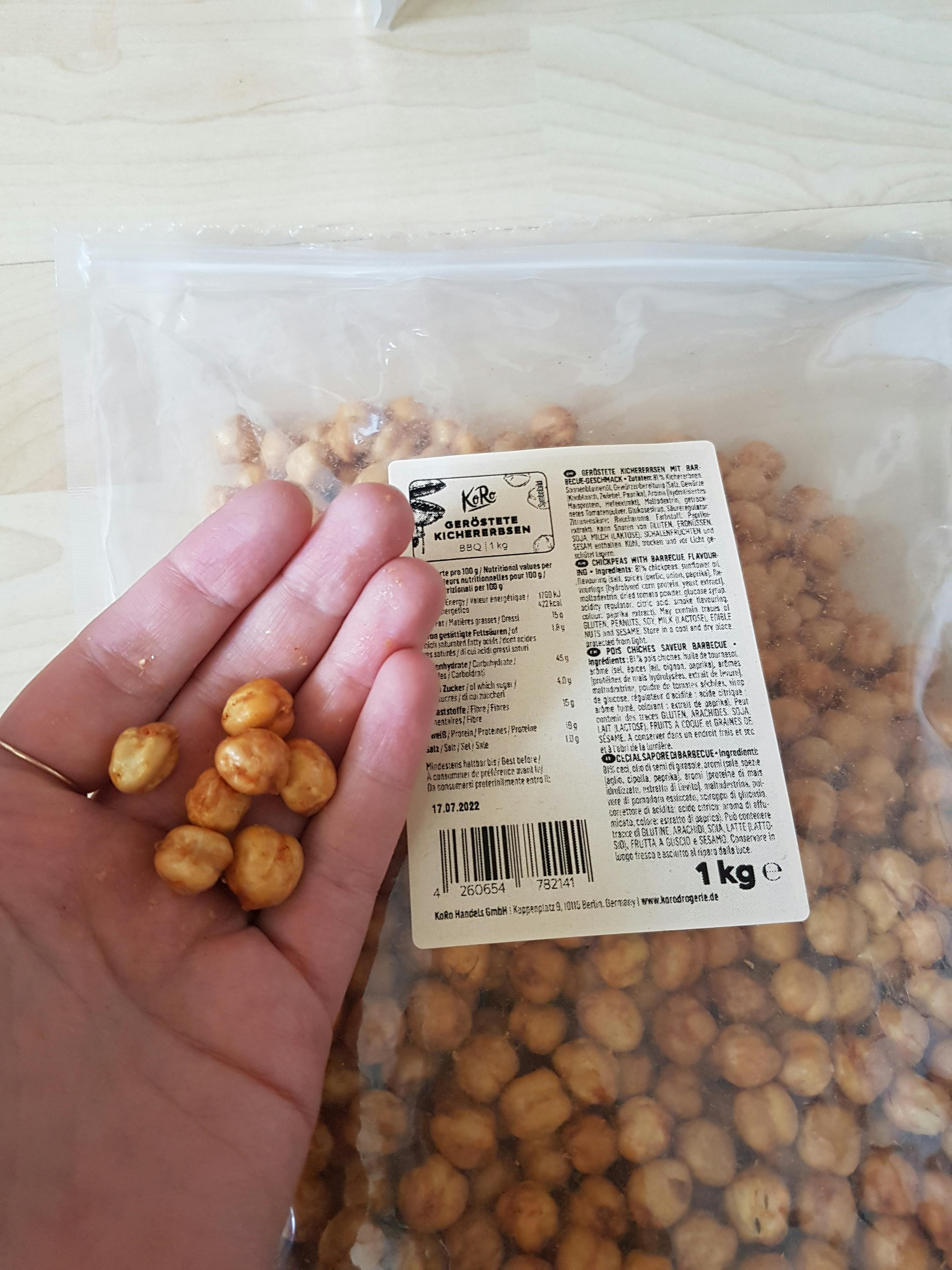 a person holding a bag of chickpeas in their hand