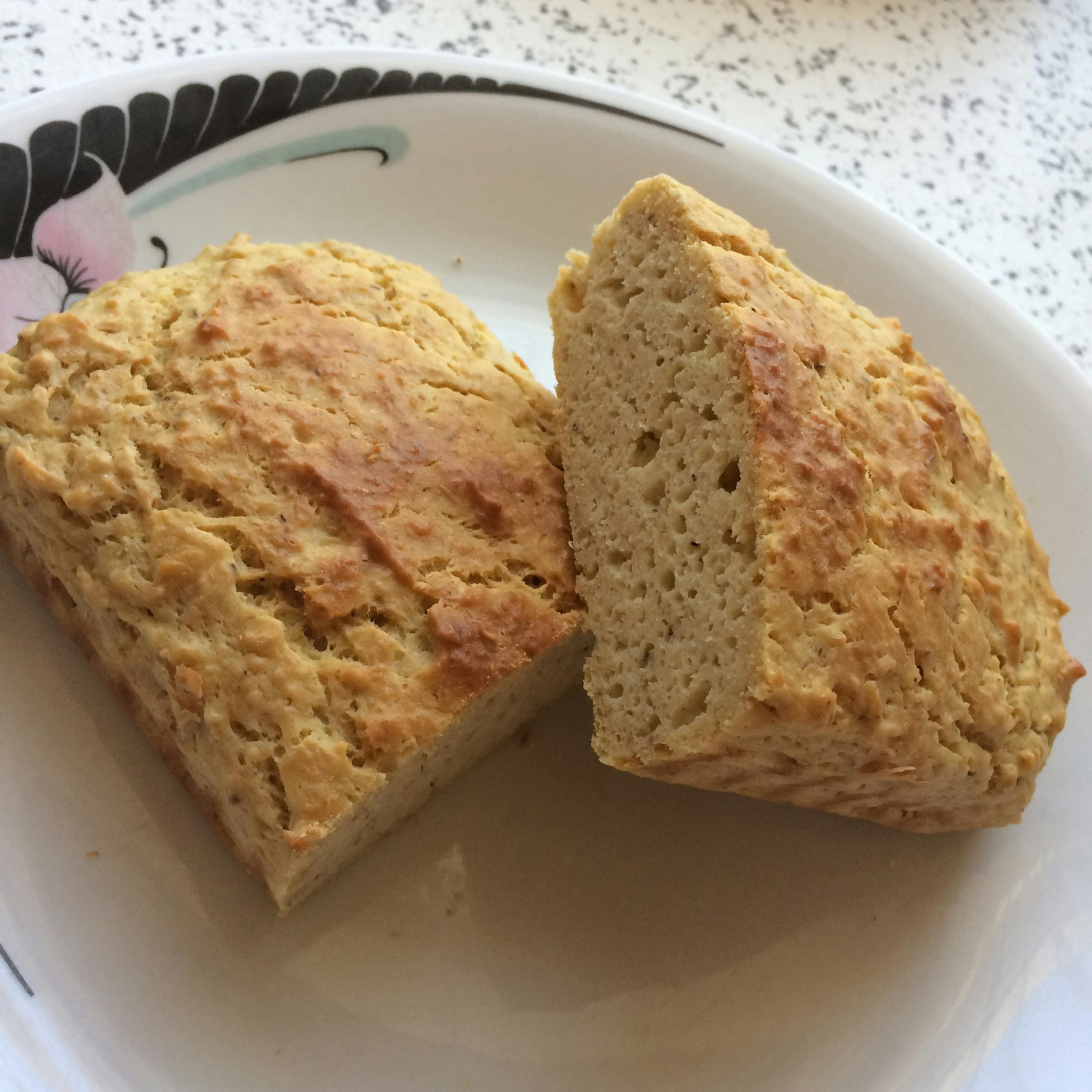 a piece of bread is cut in half on a white plate
