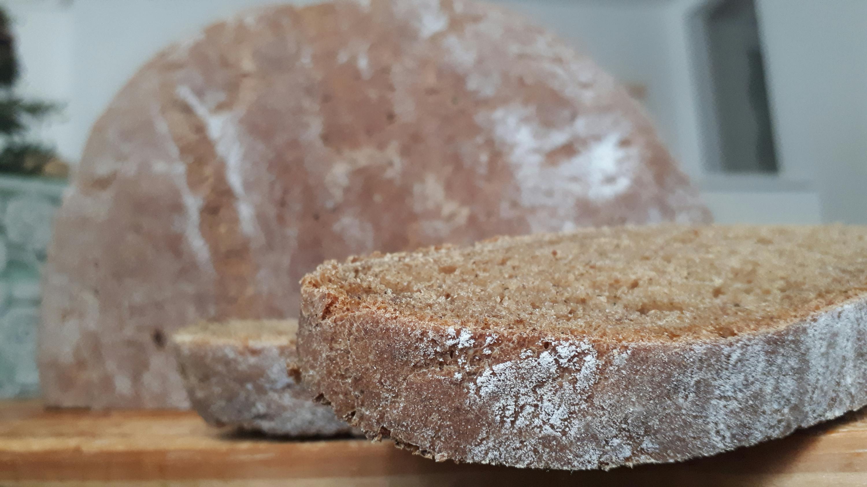 two slices of bread are sitting on a wooden cutting board