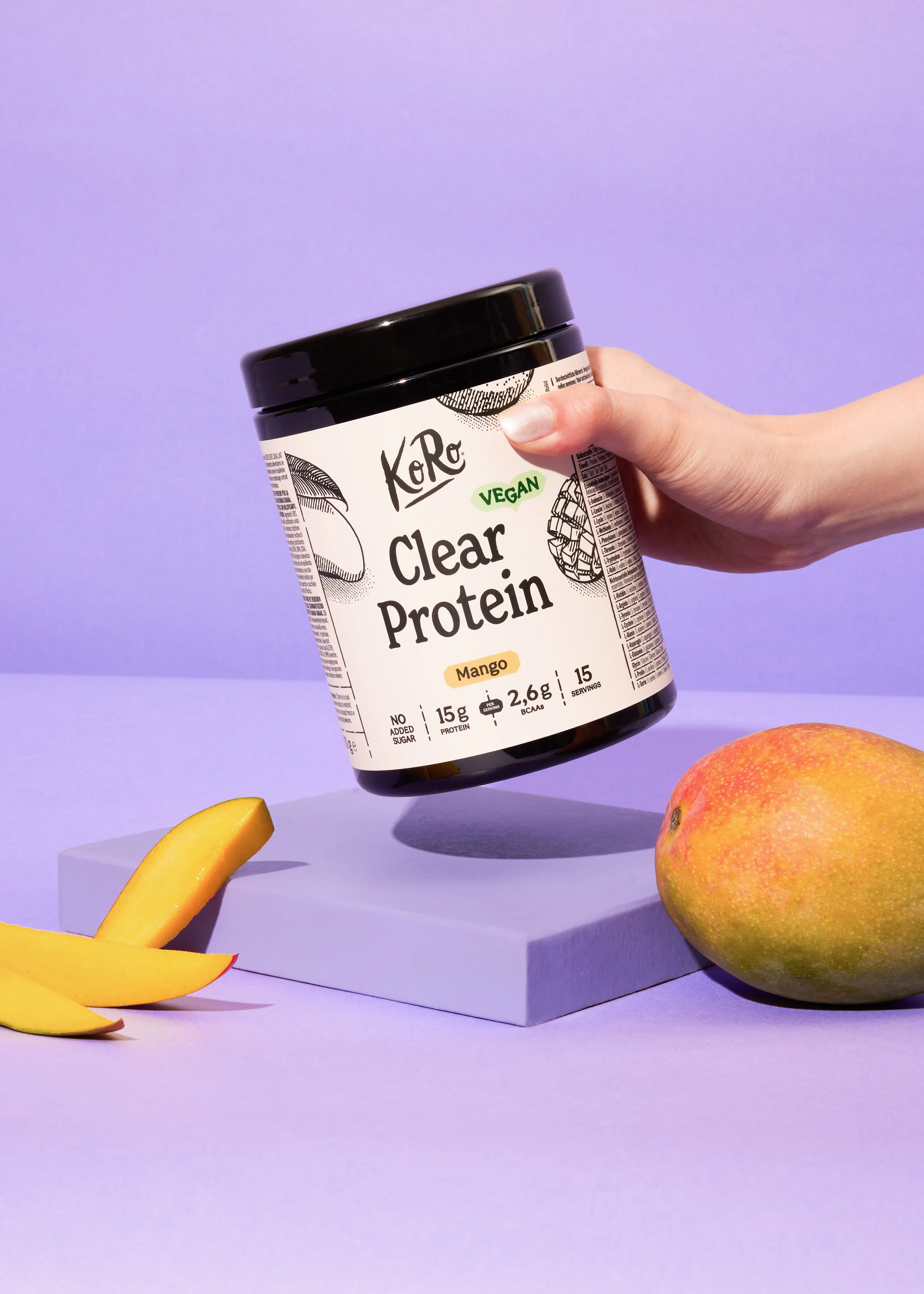 a person is holding a container of clear protein mango