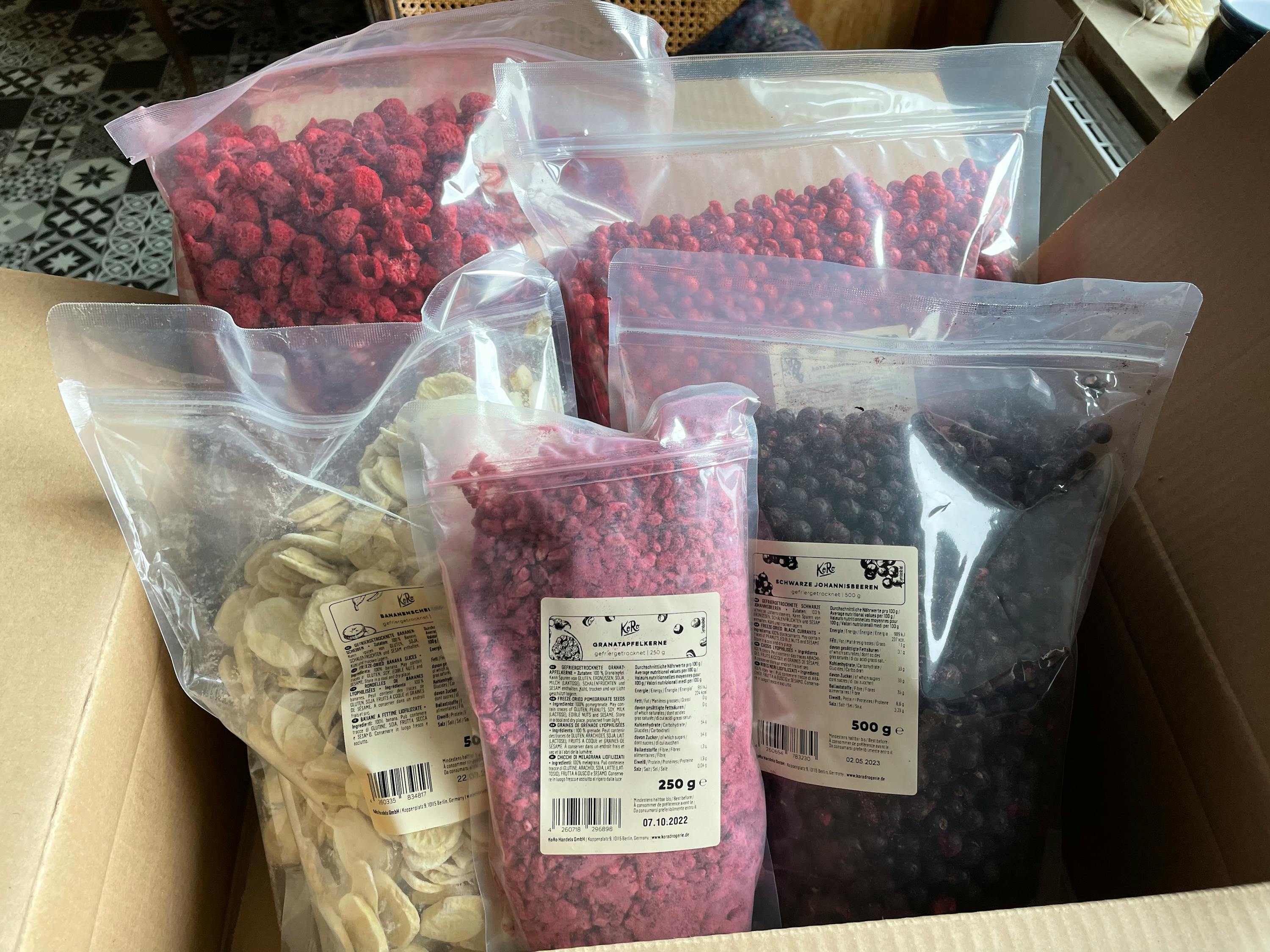 a box filled with a variety of dried fruits including raspberries blueberries and bananas