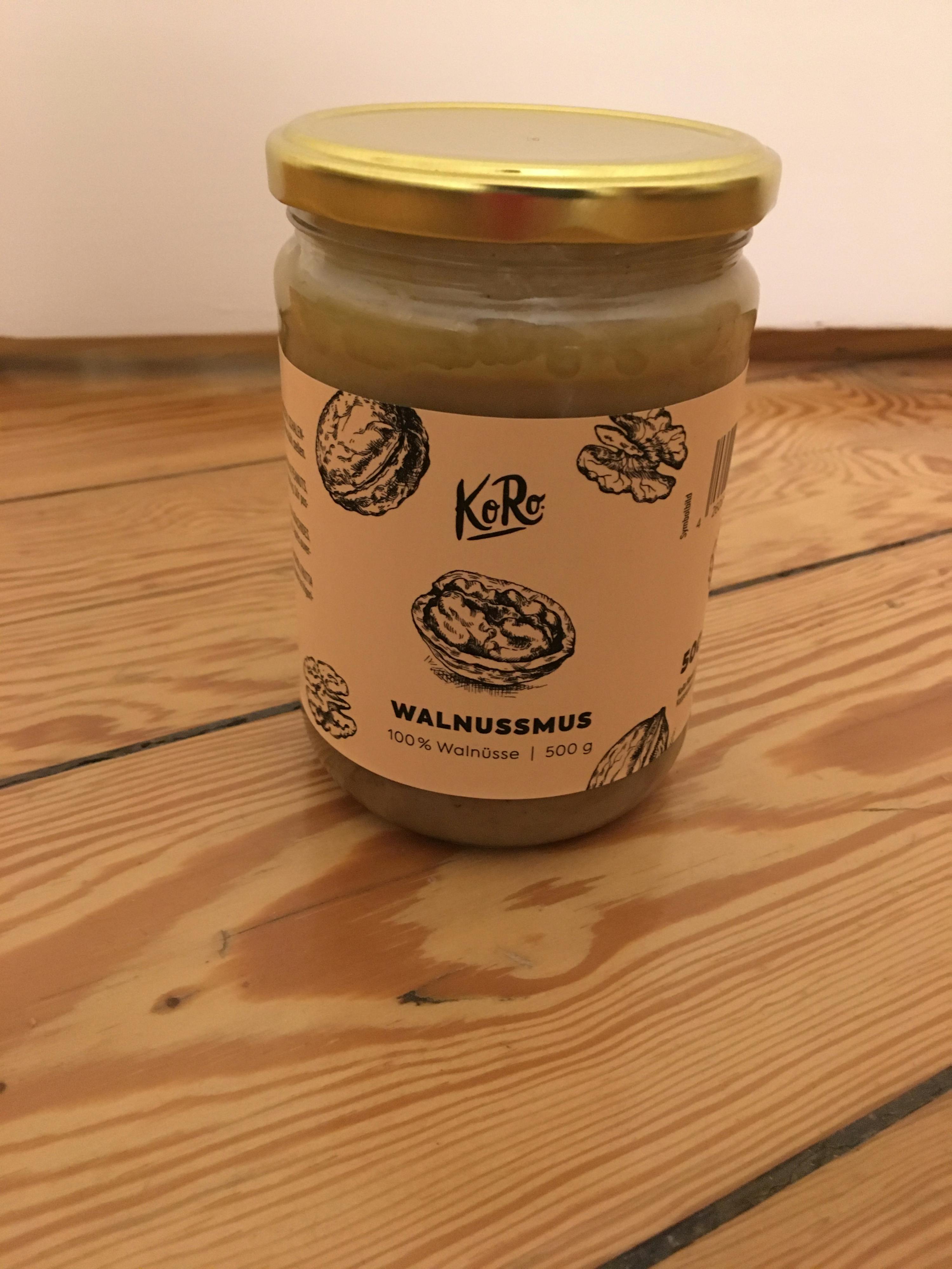 a jar of walnutmus is sitting on a wooden table