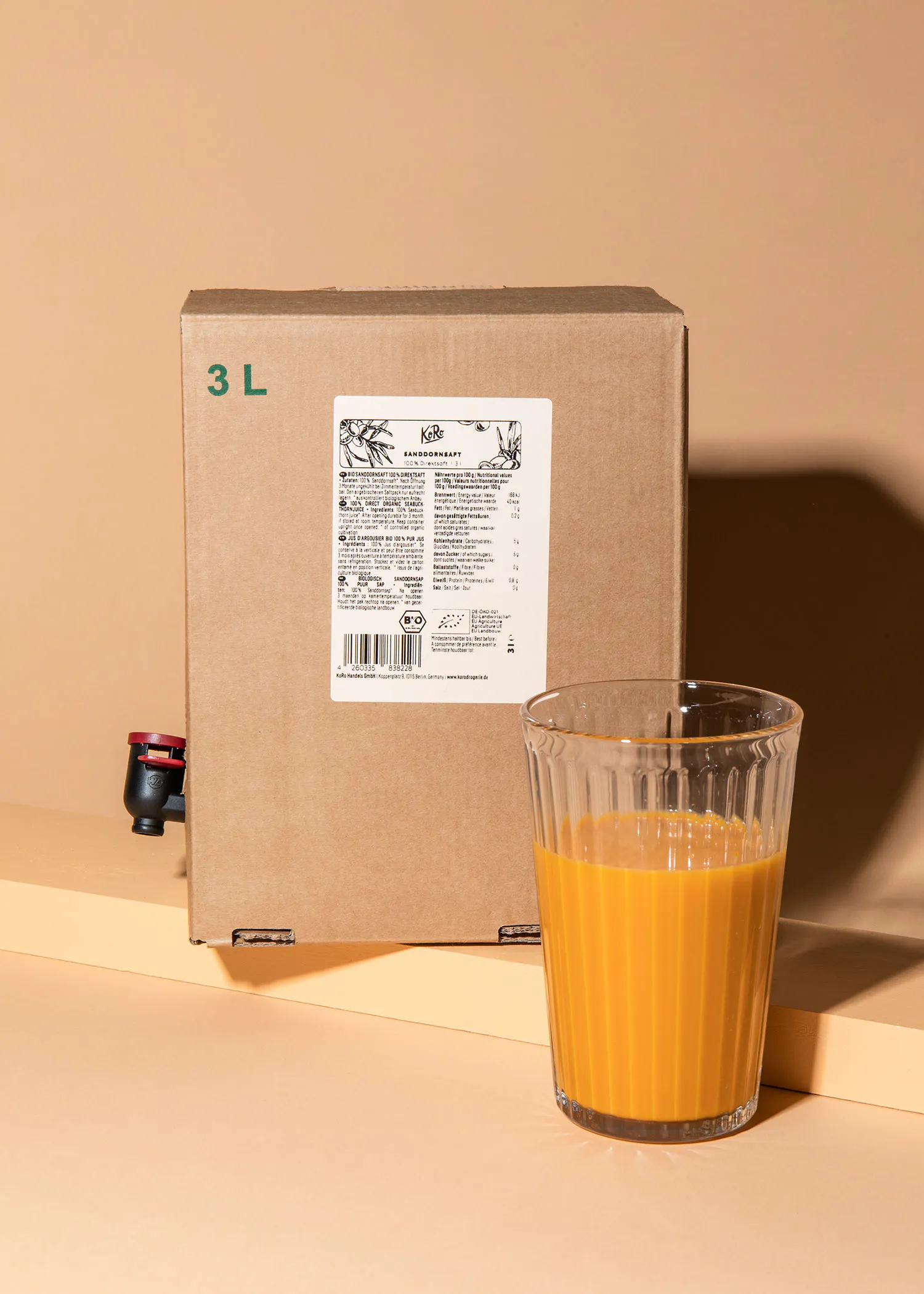 a box with the letter l on it next to a glass