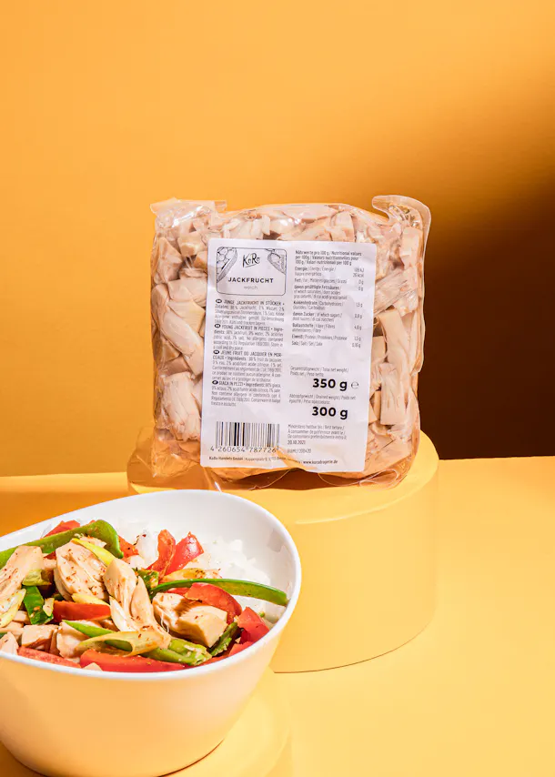 a package of jackfruit sits next to a bowl of food