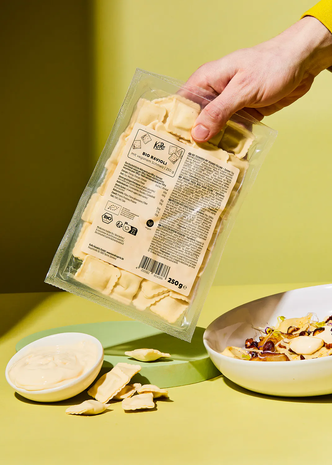 a person is holding a bag of ravioli that says bio