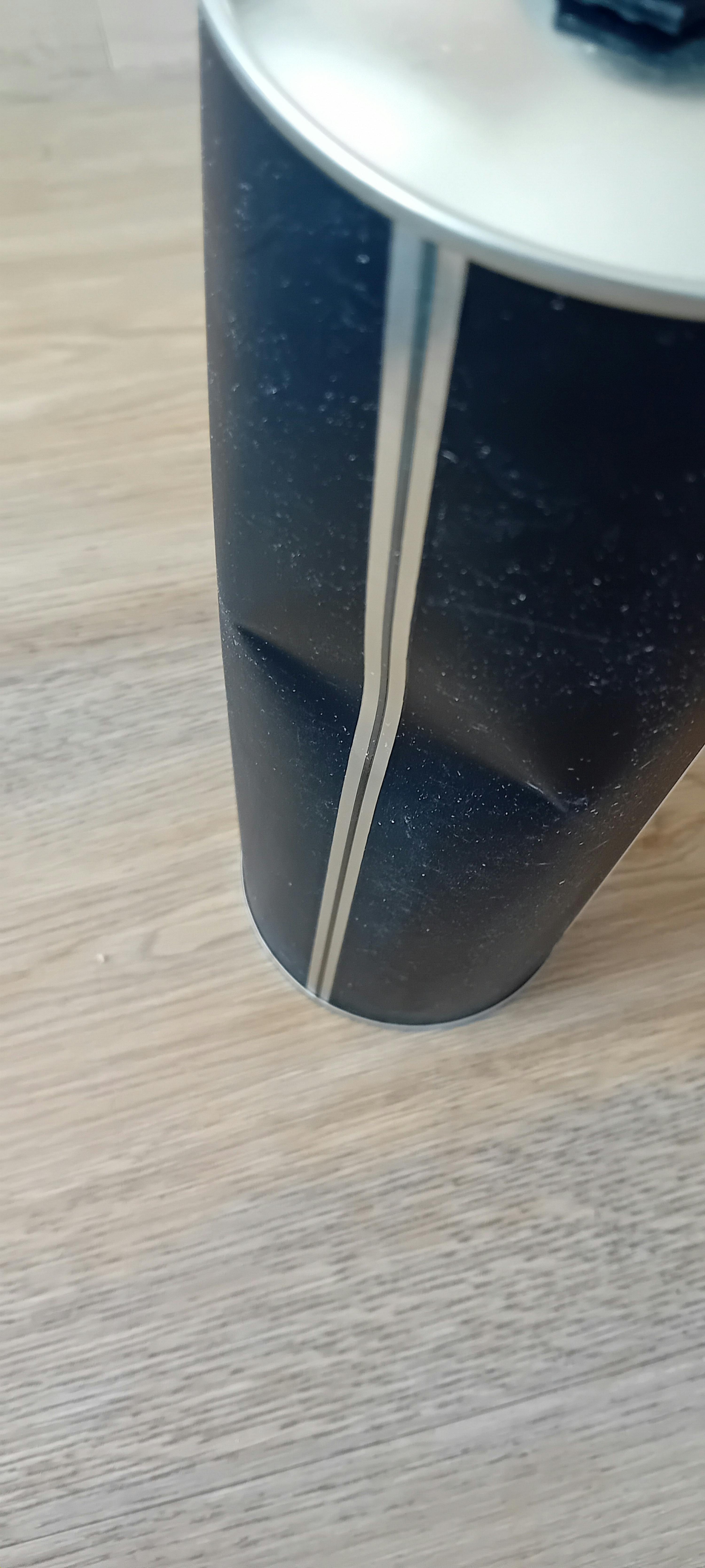 a close up of a metal object on a wooden surface