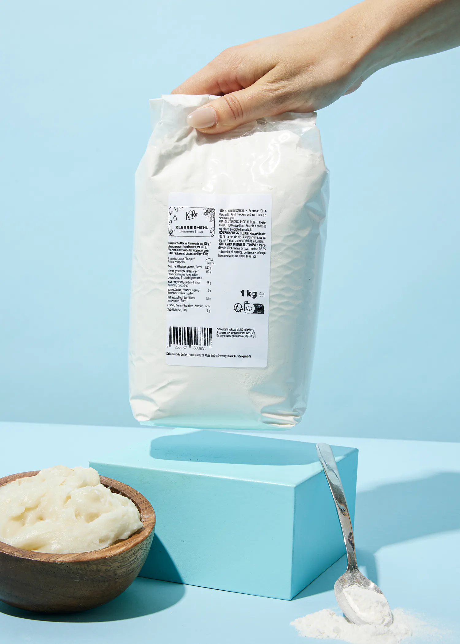 a person is holding a bag of flour with a label that says 1 kg