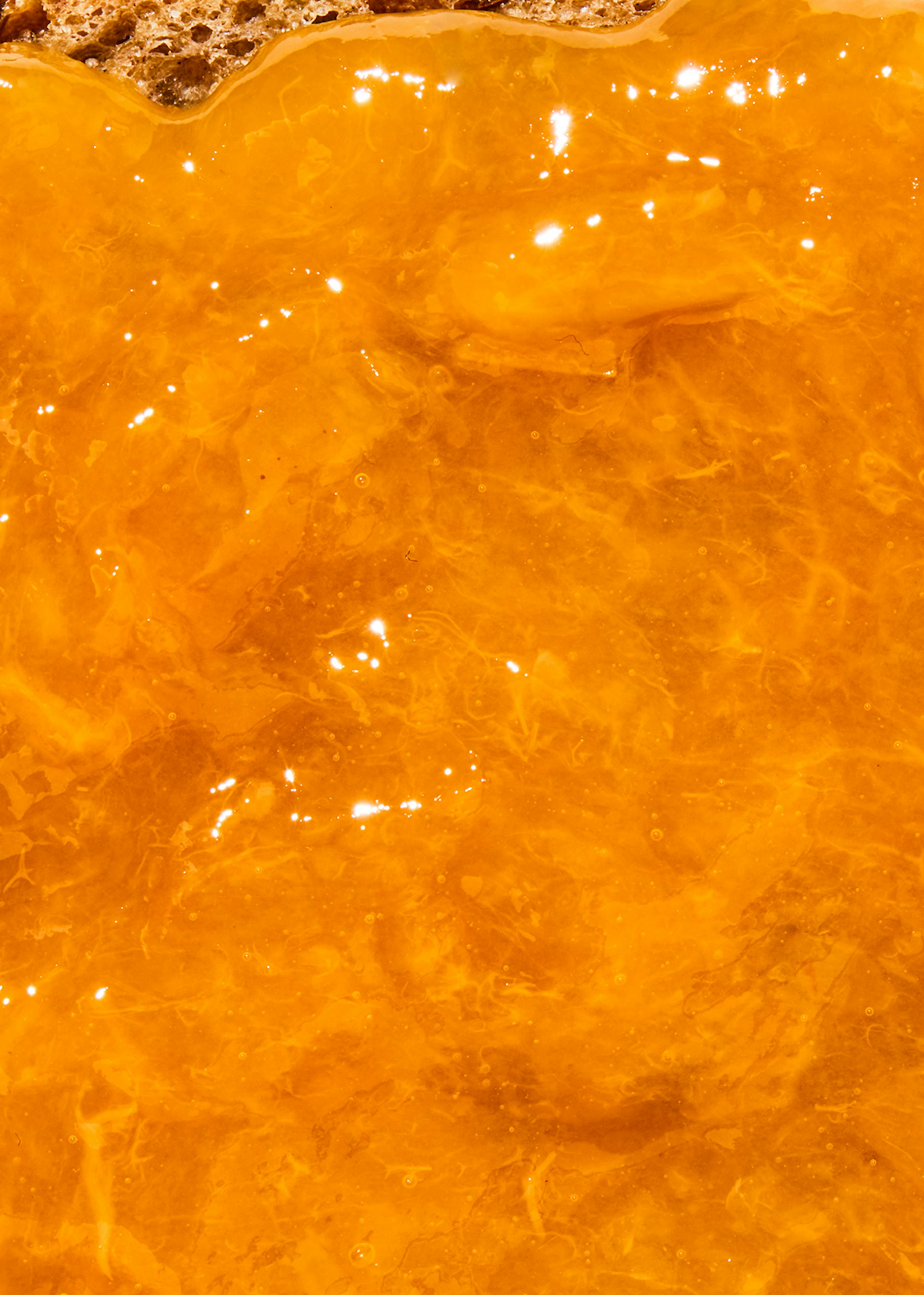 a close up of a yellow liquid with bubbles in it