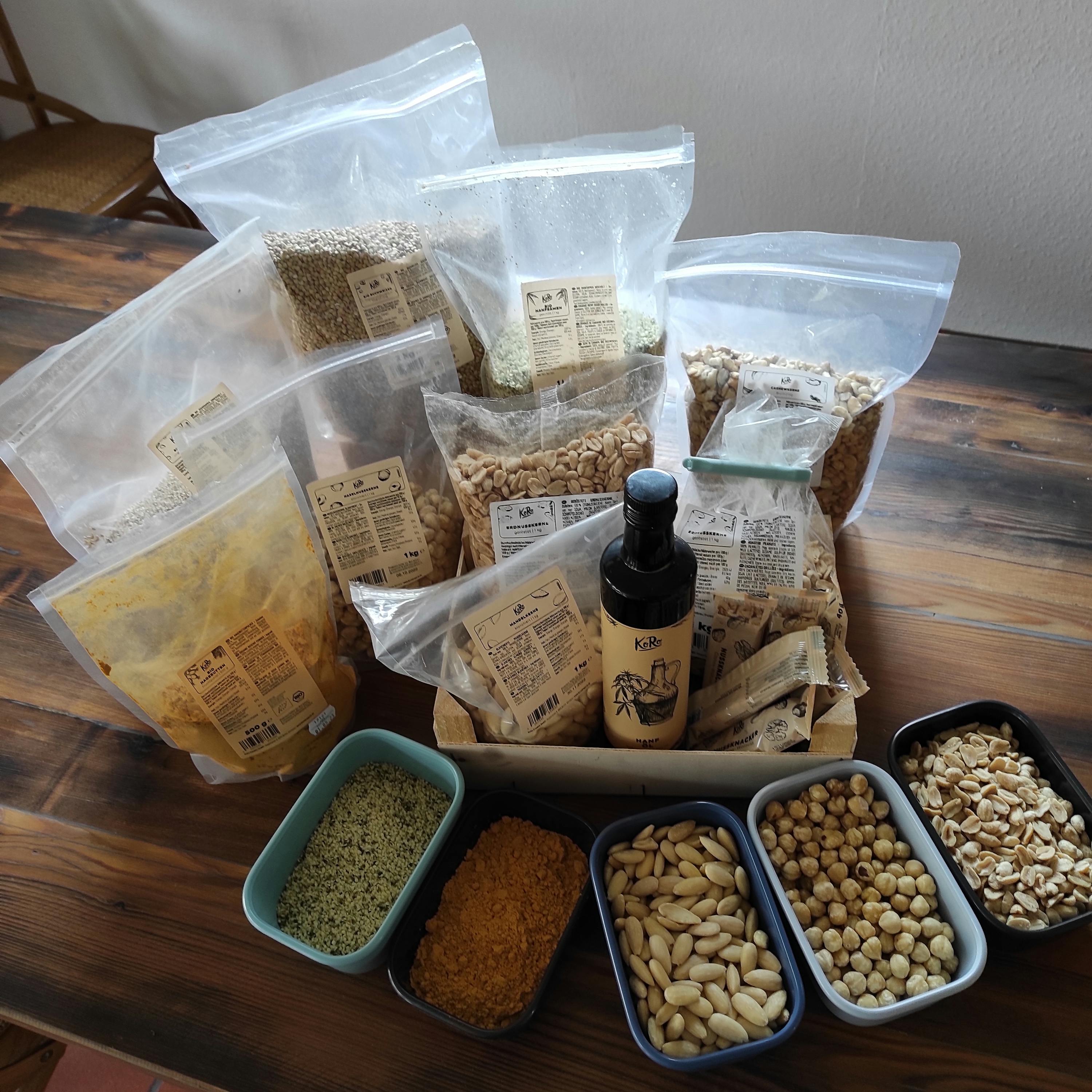 auf einem holztisch steht eine kiste mit verschiedenen trockenfrüchten