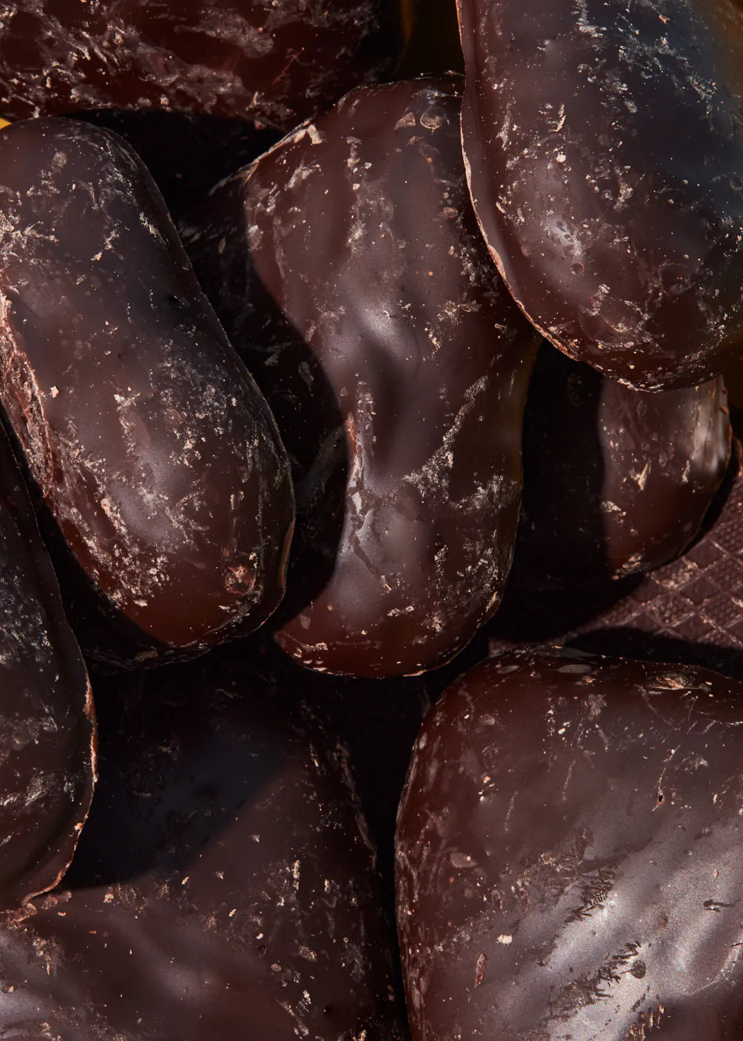 a close up of a pile of chocolate covered nuts