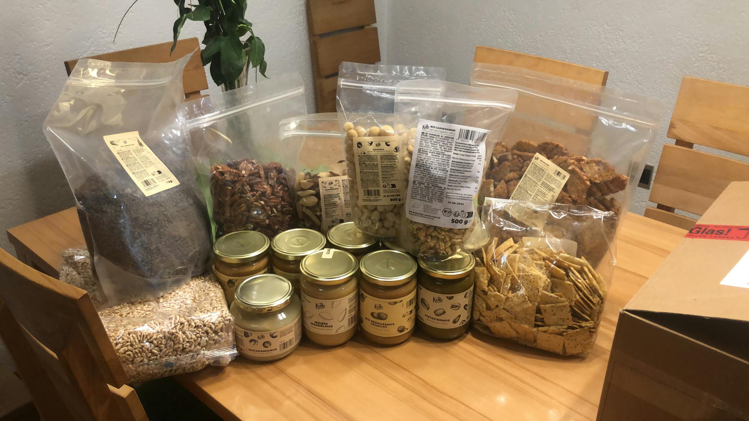 a table full of food including jars of peanut butter and crackers