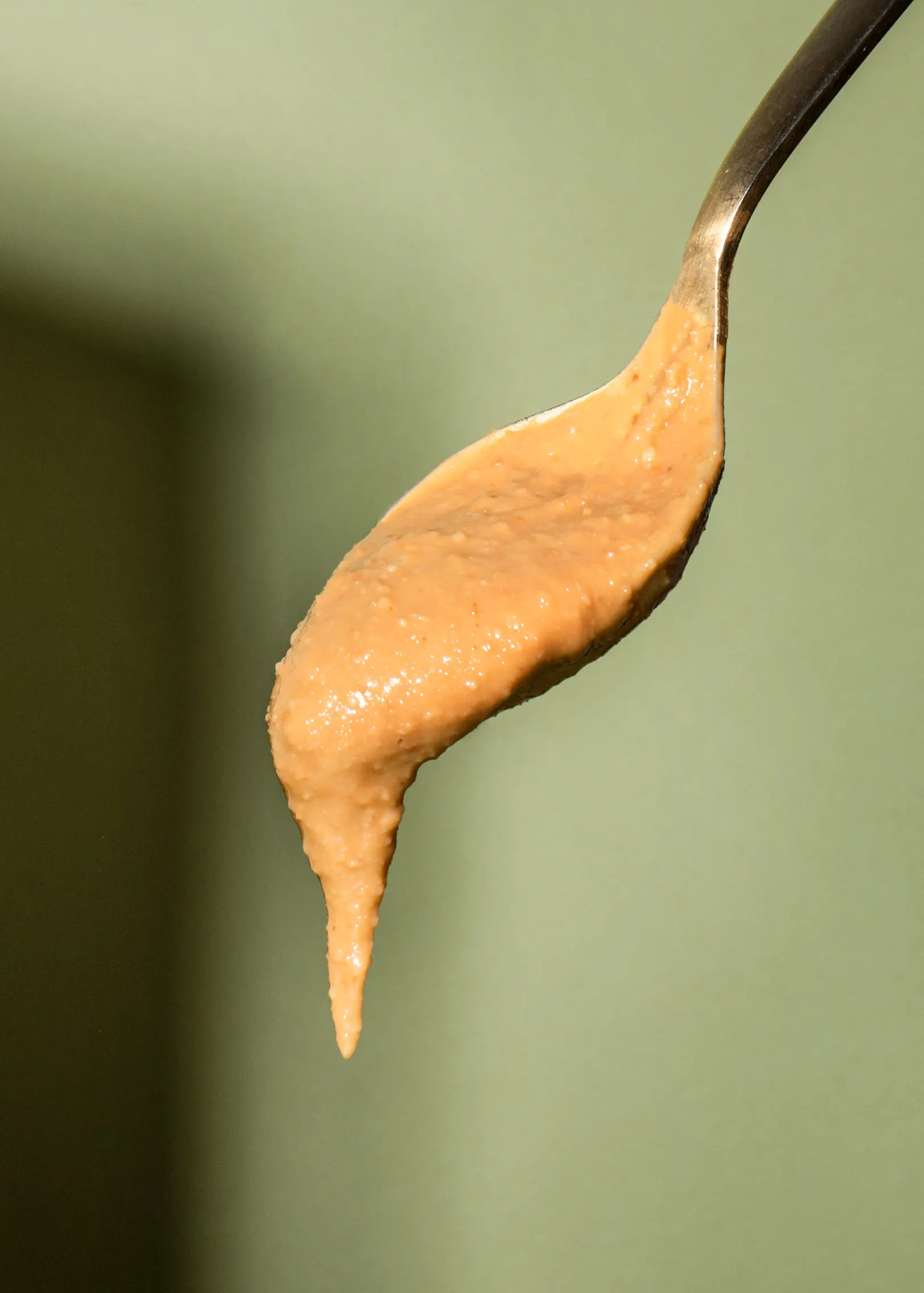 a close up of a spoon filled with peanut butter
